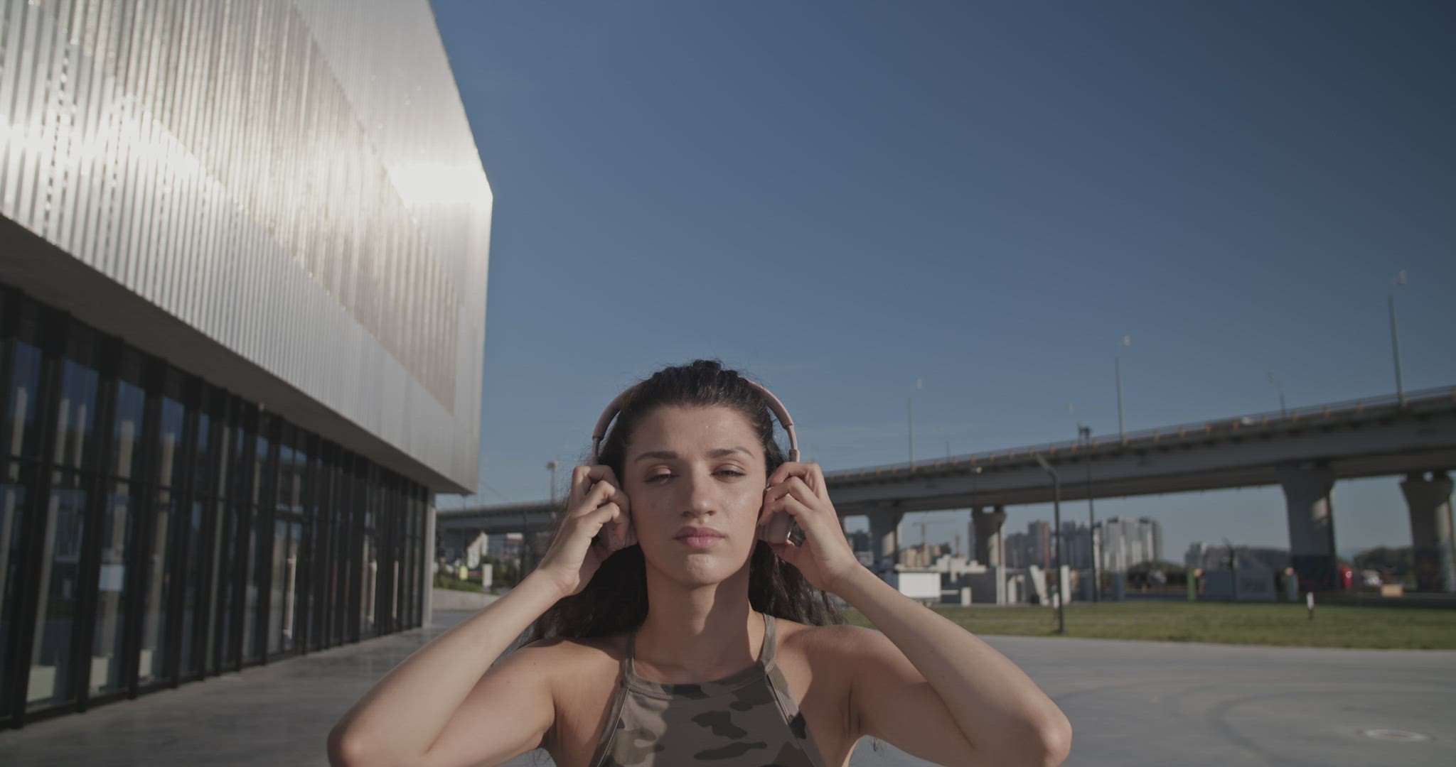 Young brunette removing headset and touching hair