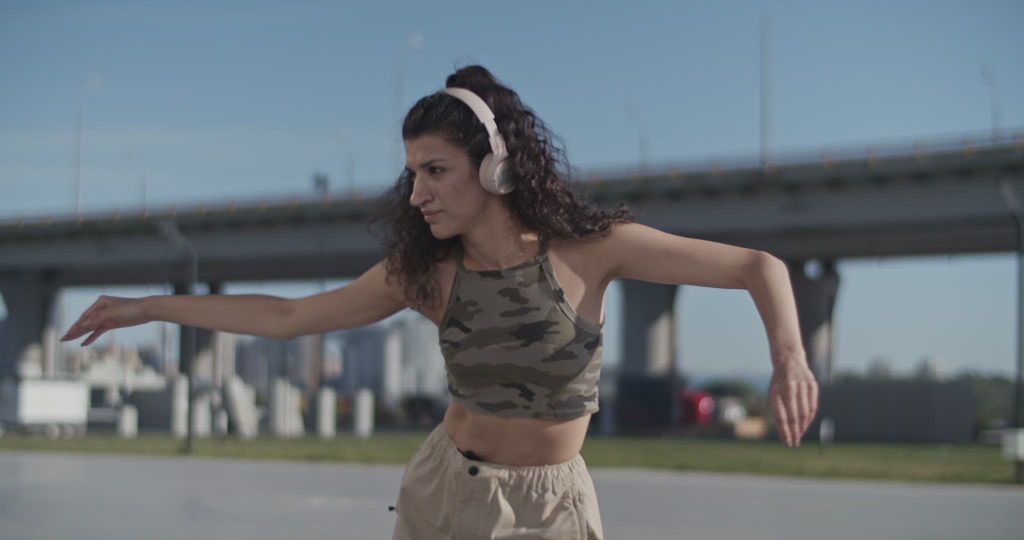 Graceful brunette listening to music and dancing in morning
