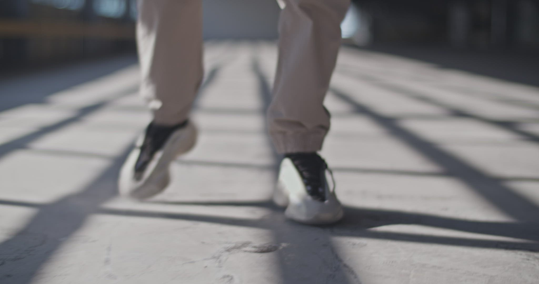 Cropped woman dancing on sunlit floor