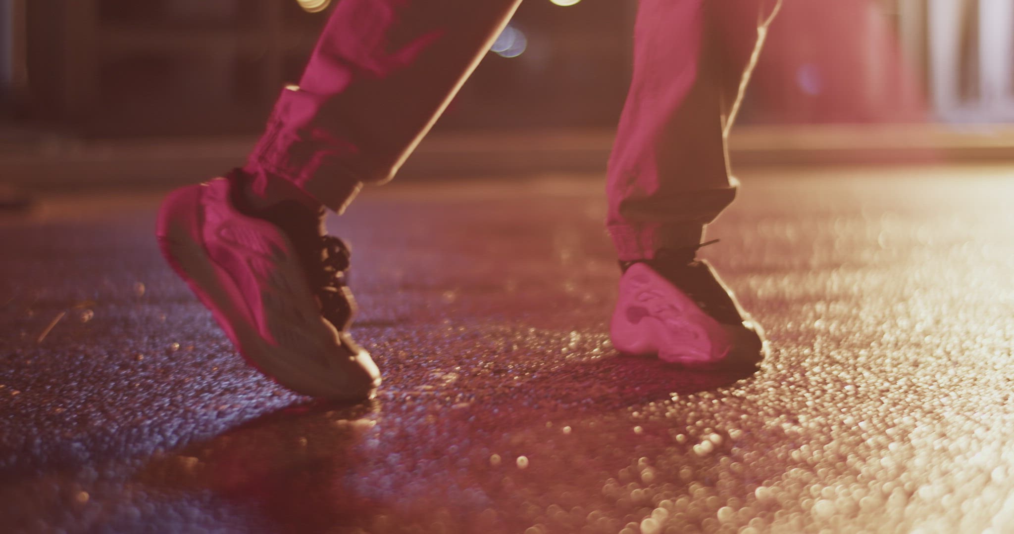 Cropped woman dancing on wet asphalt