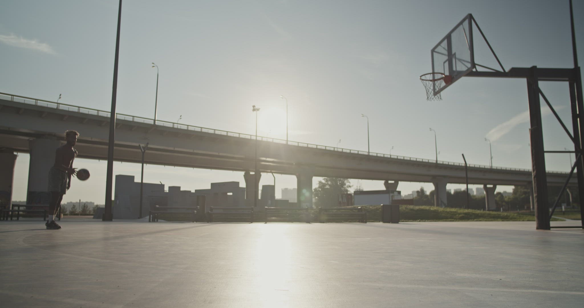 Basketball player throwing ball in hoop