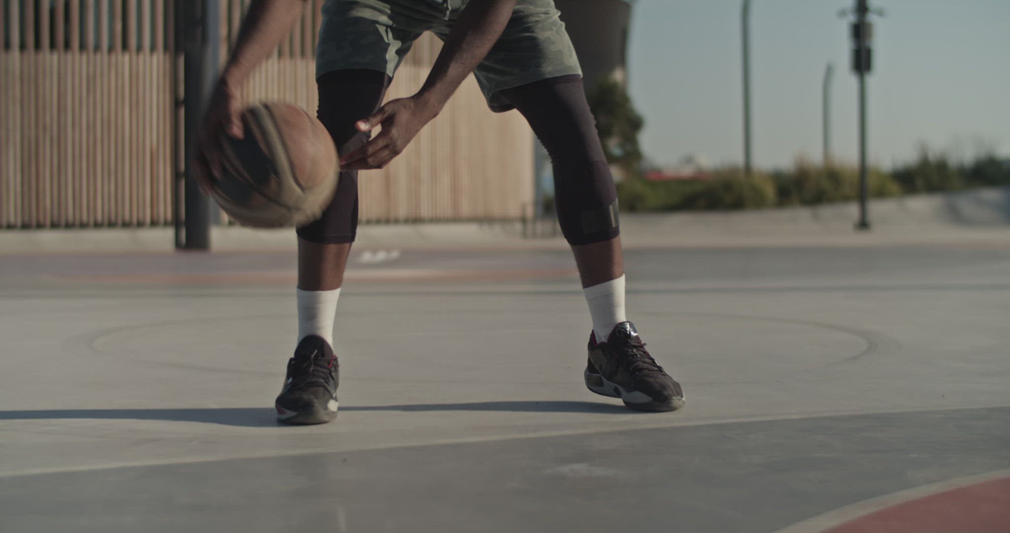 Cropped basketball player dribbling ball during training