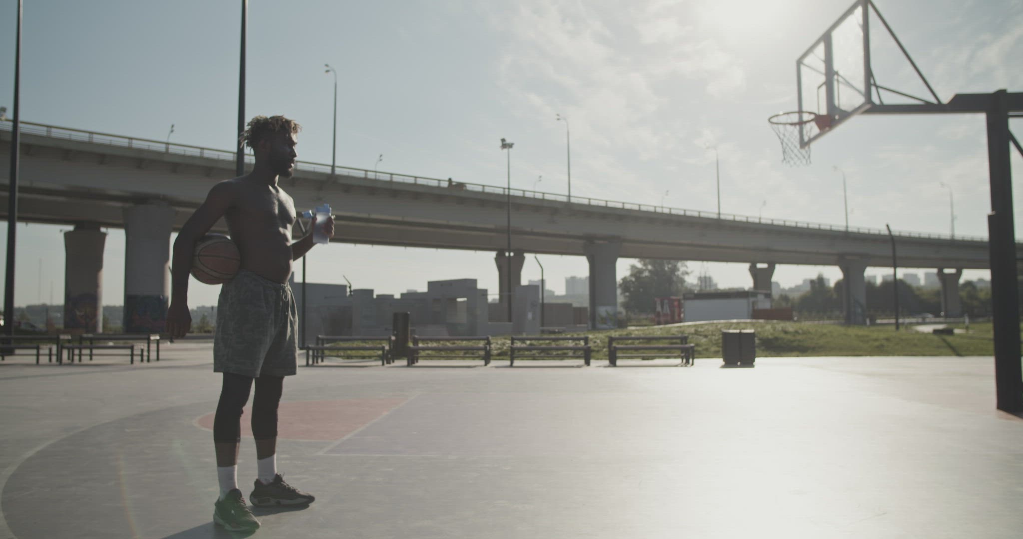 Black basketball player drinking water