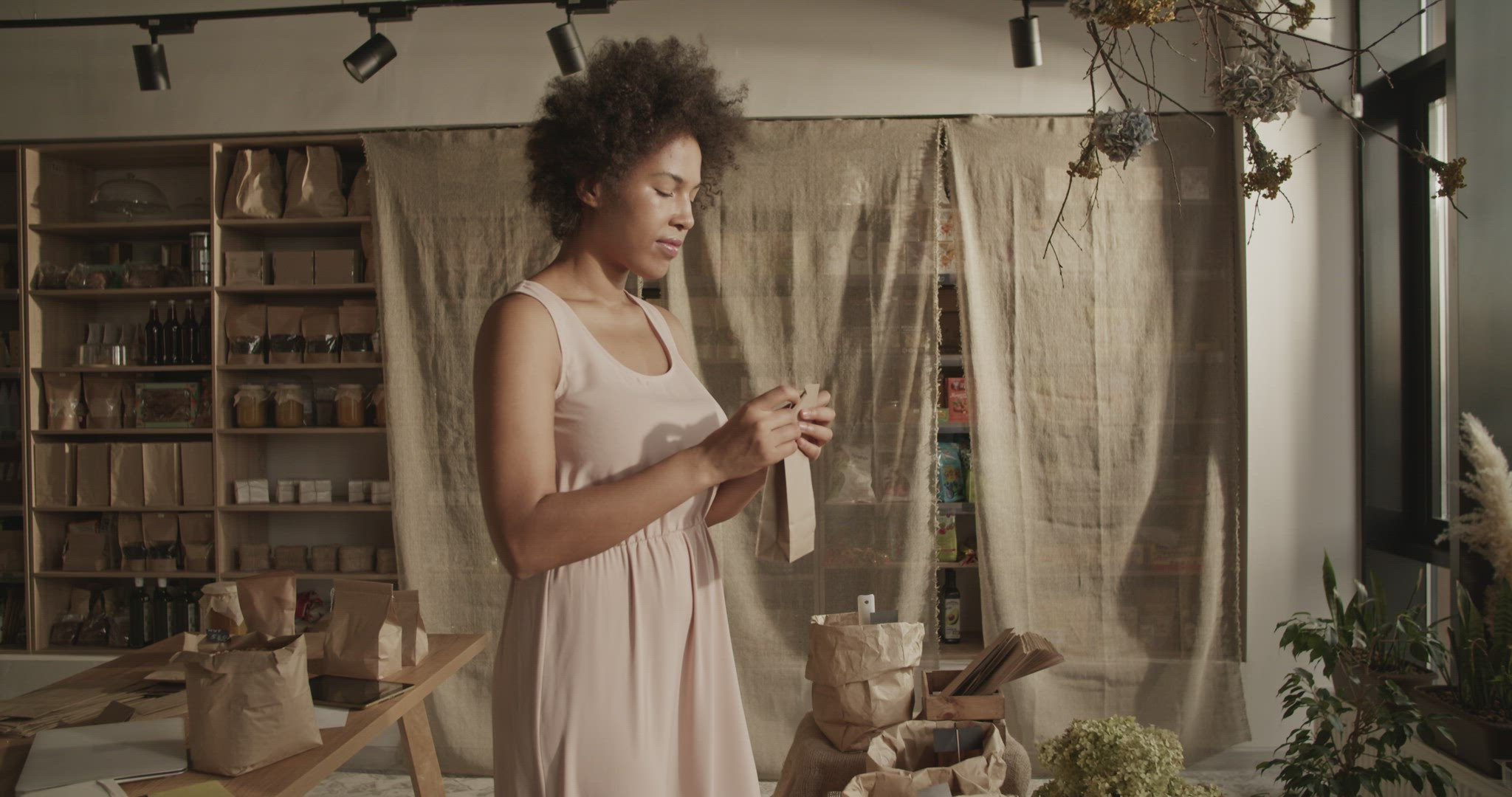 Content woman packing eco product for order