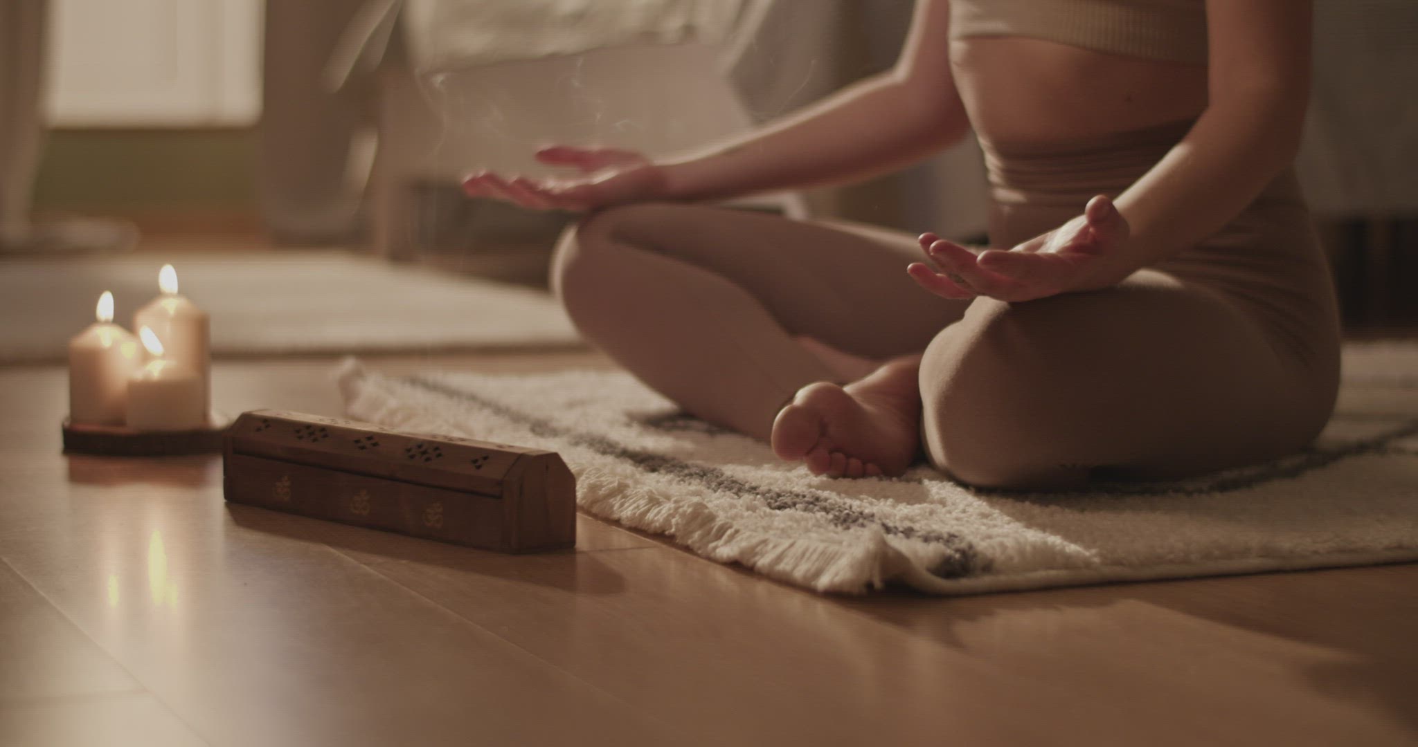 Woman meditating on floor in morning