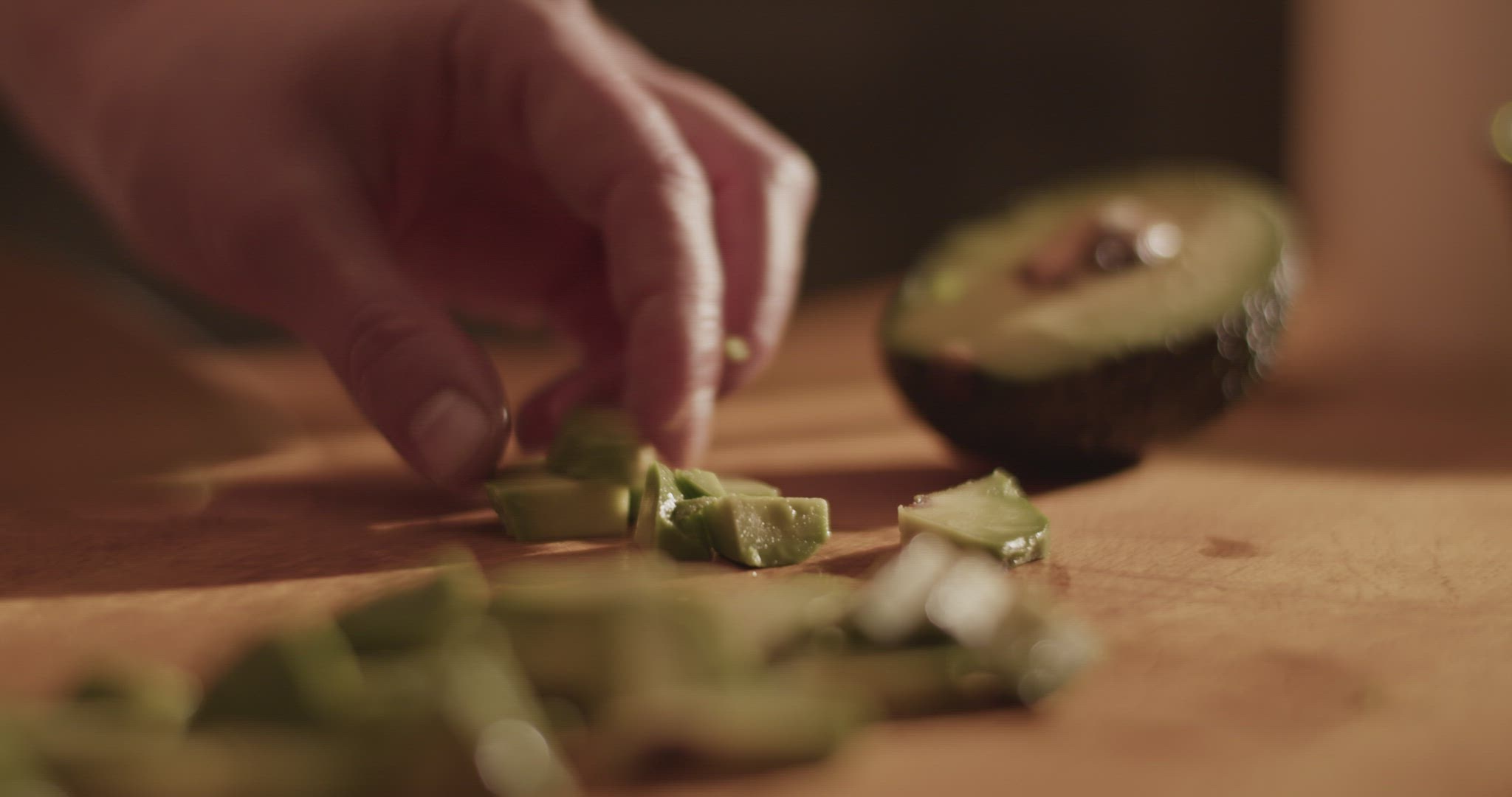 Crop woman slicing fresh avocado
