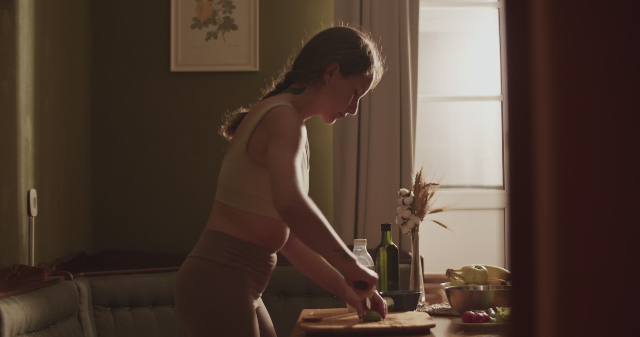 Woman cutting avocado for salad