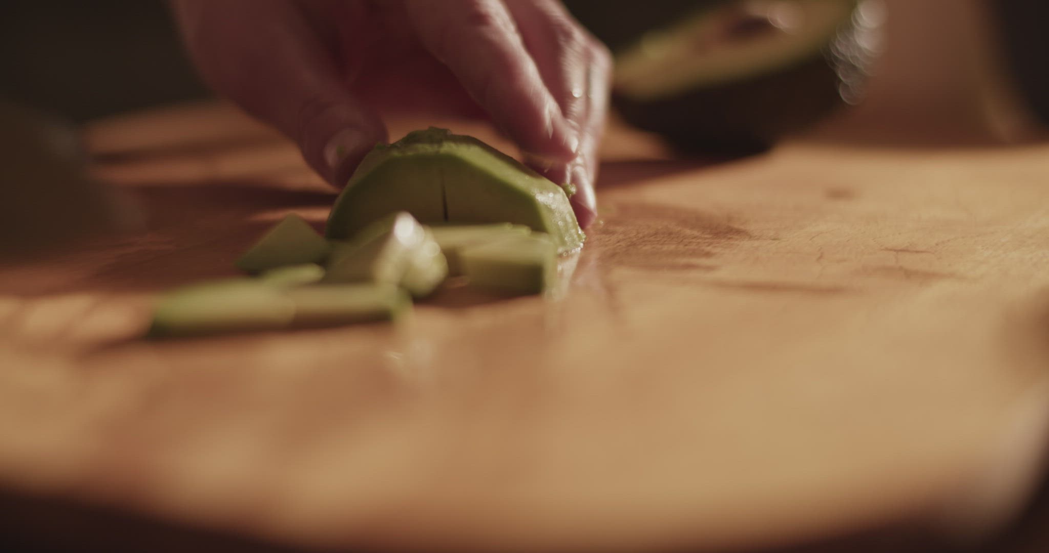 Crop woman slicing fresh avocado