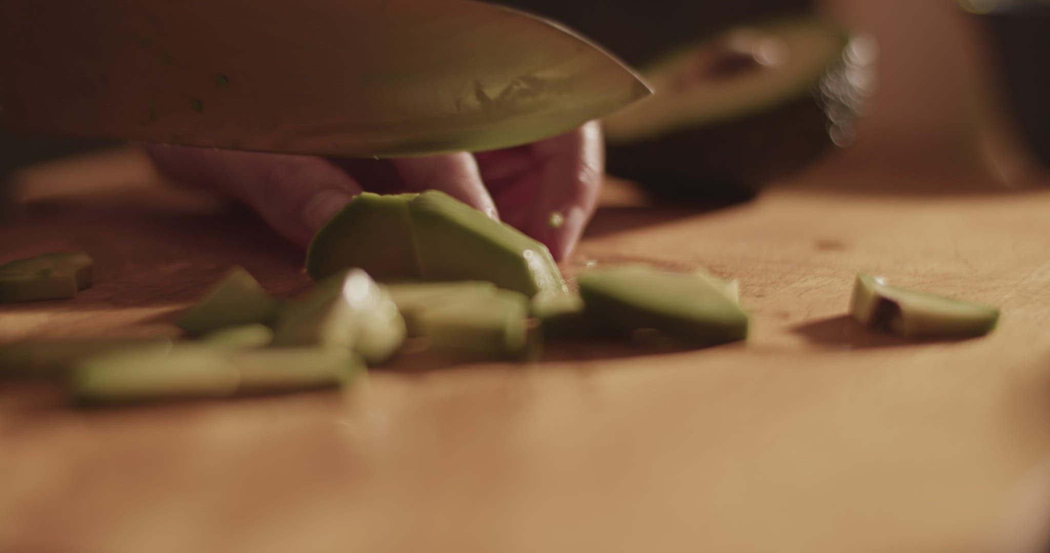 Crop woman slicing fresh avocado