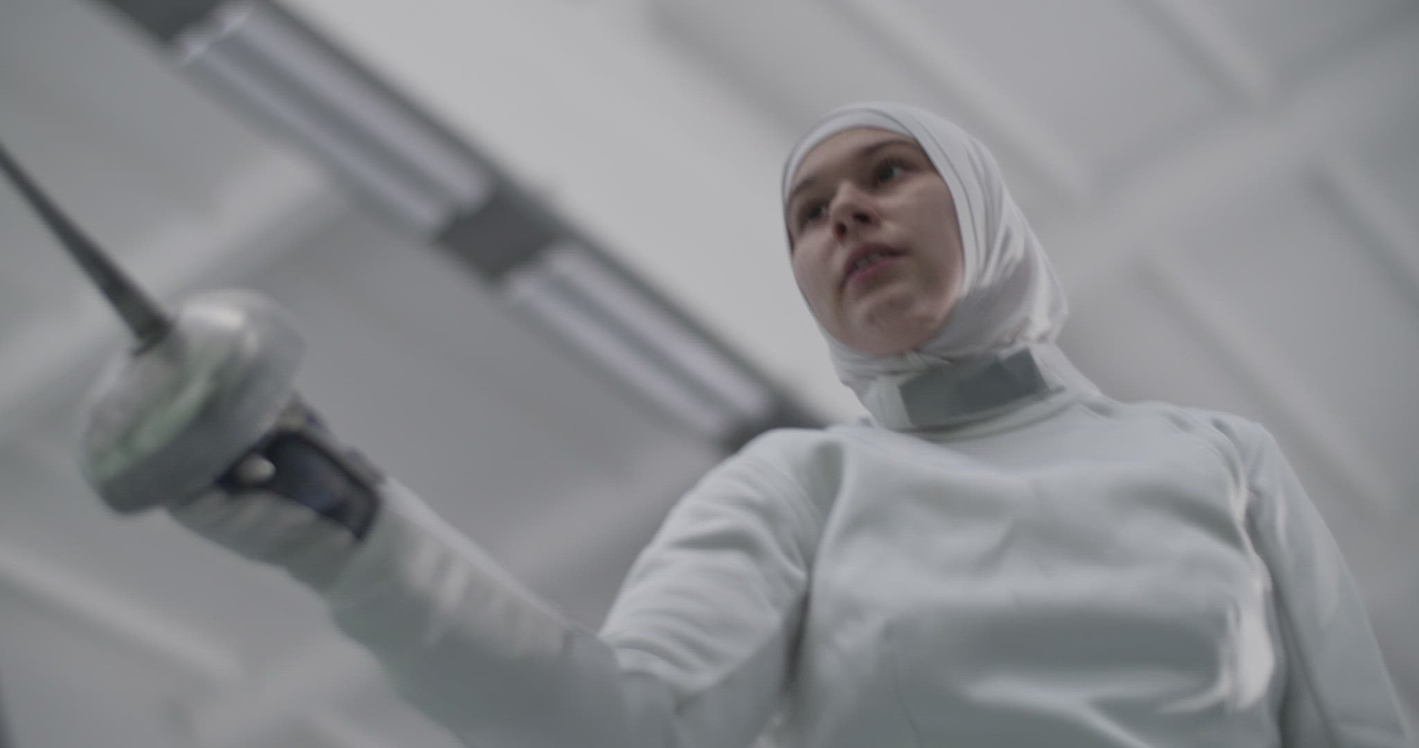 Muslim fencer hitting air with foil