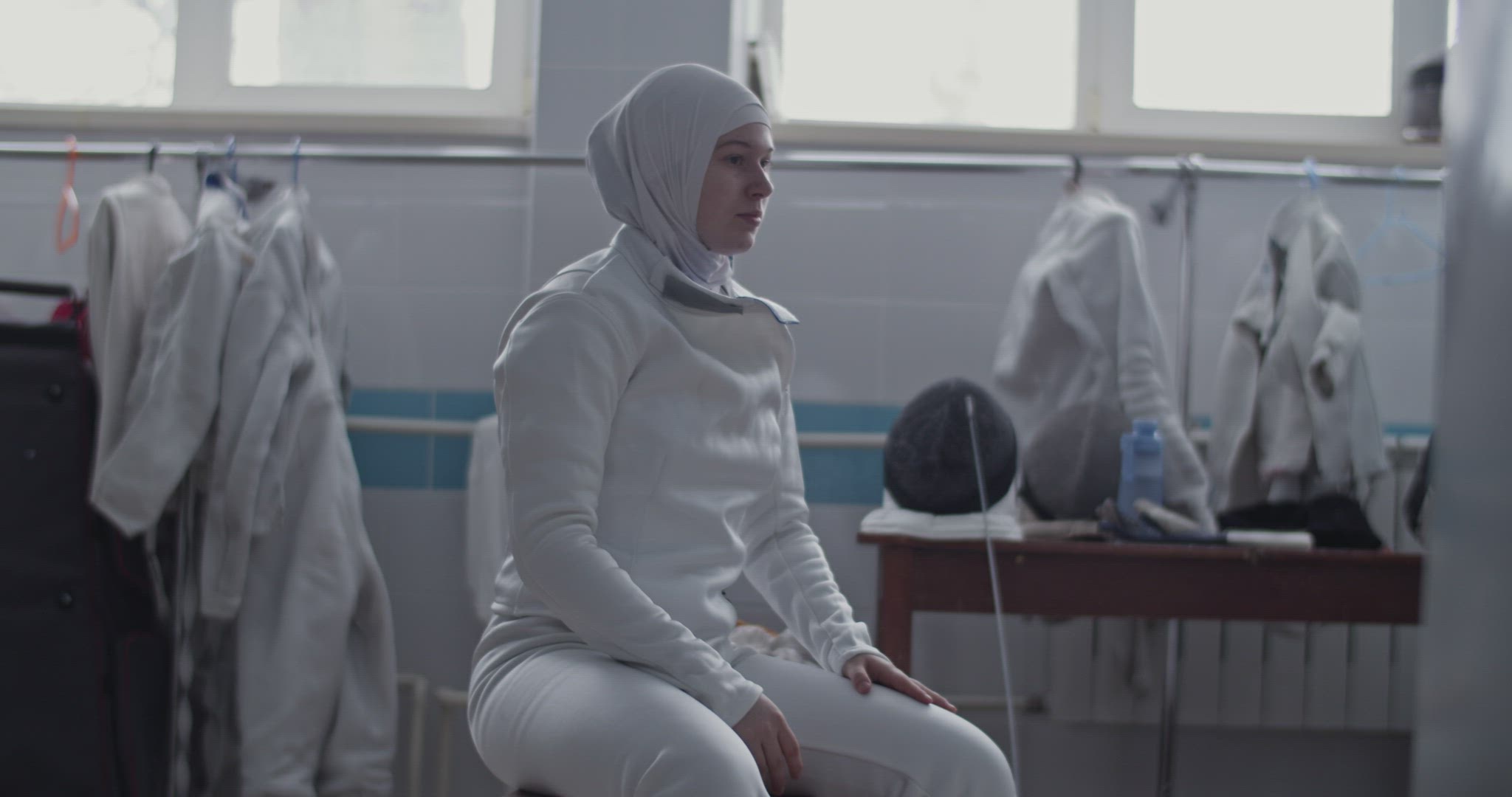 Muslim fencer getting dressed for workout