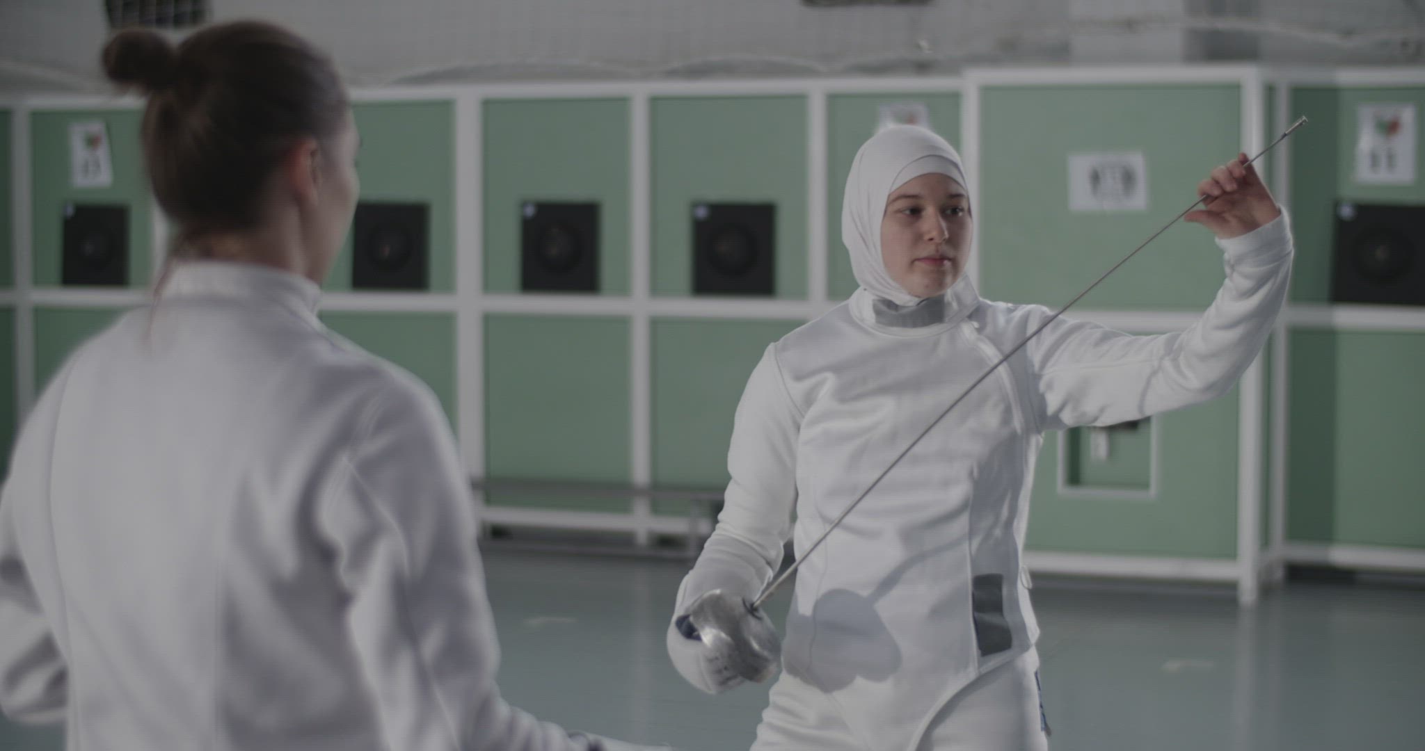 Muslim fencer speaking with opponent