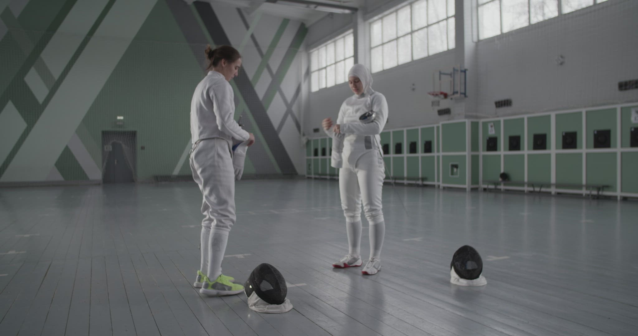 Diverse female fencers preparing for training