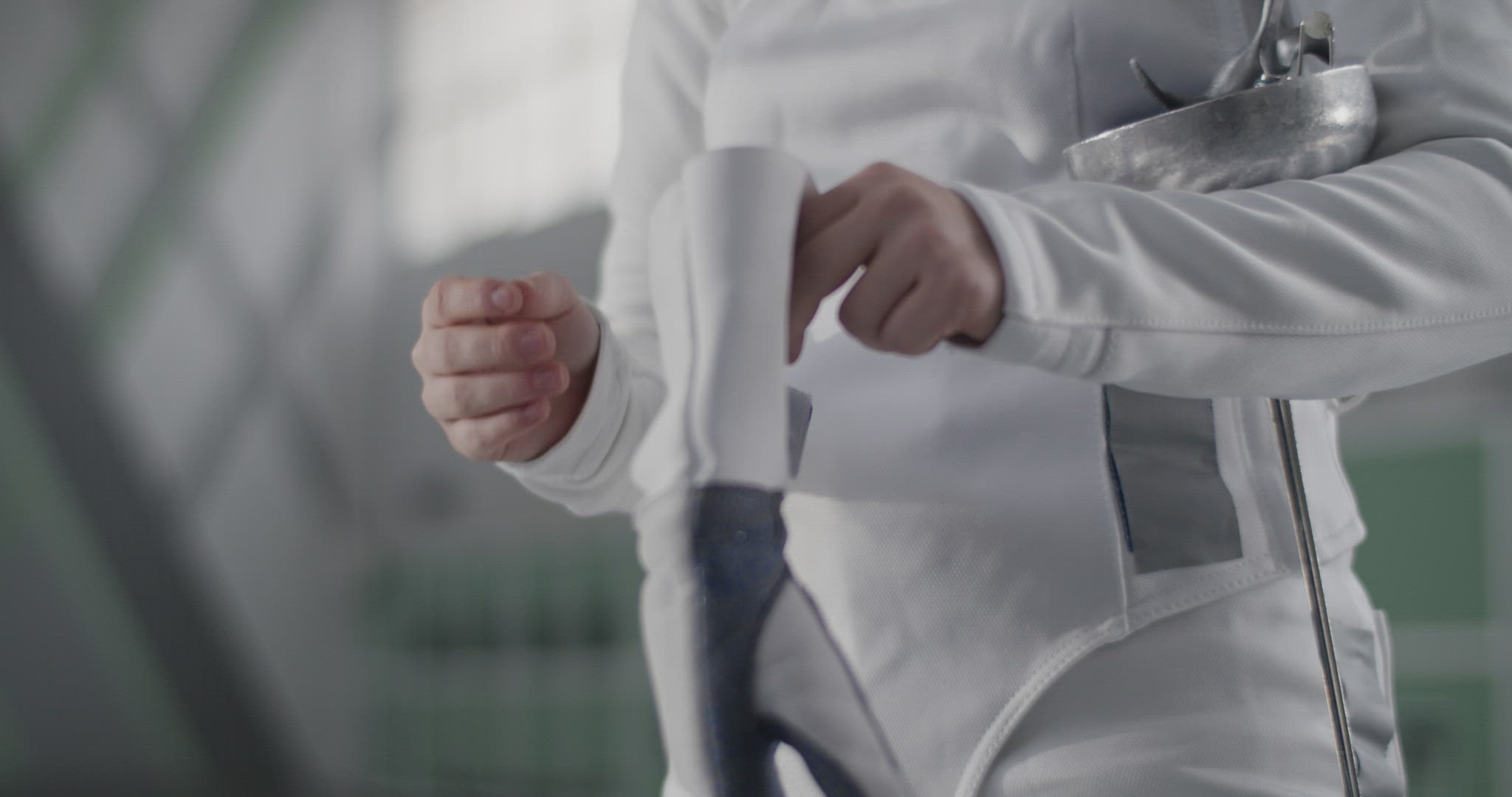 Crop fencer putting on glove