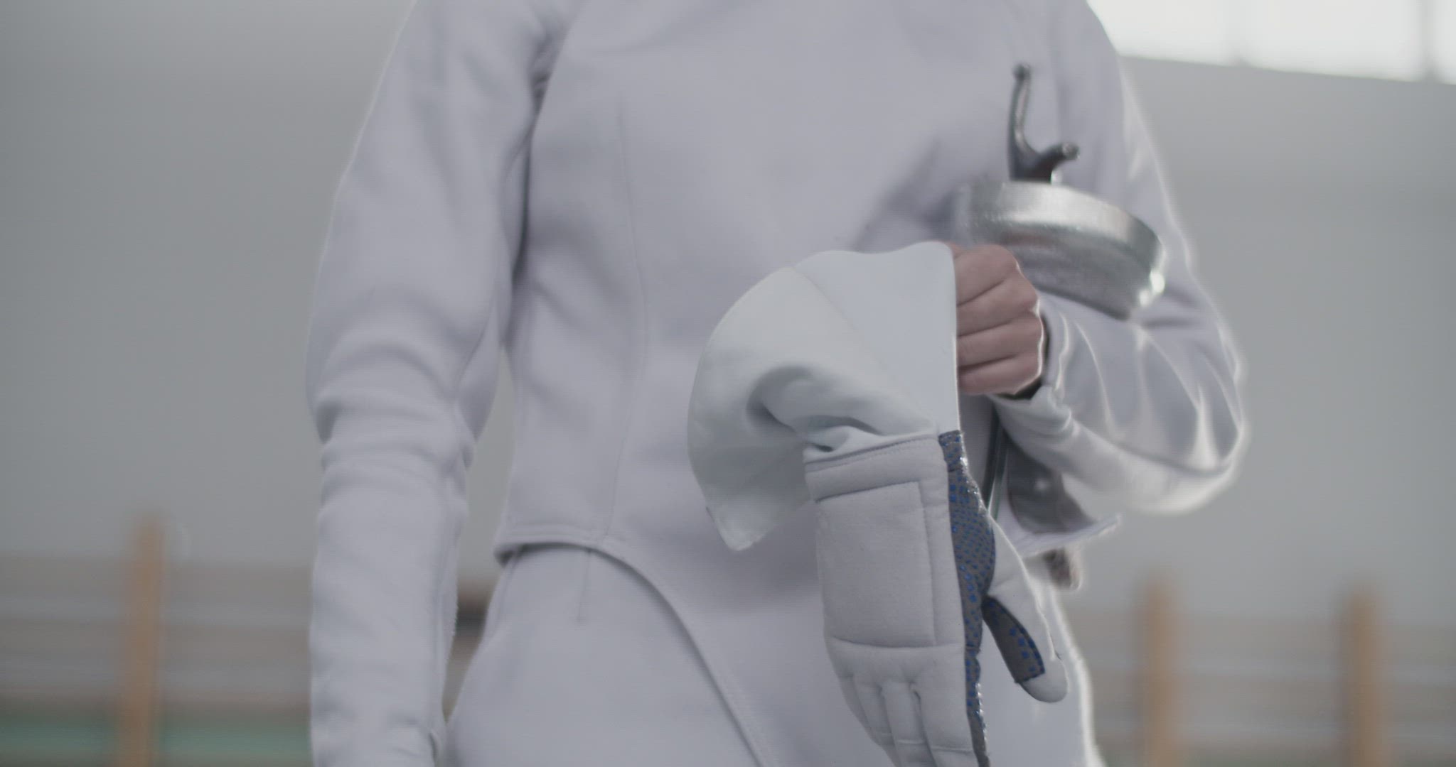 Crop fencer putting on glove