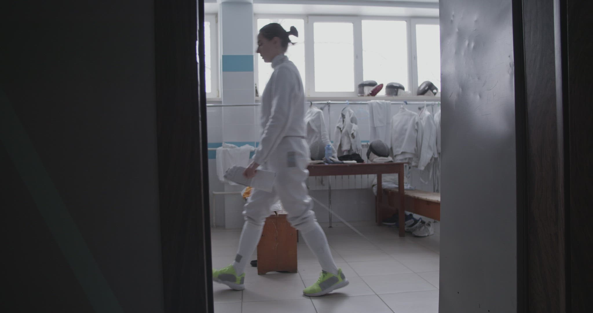 Female fencer walking in dressing room