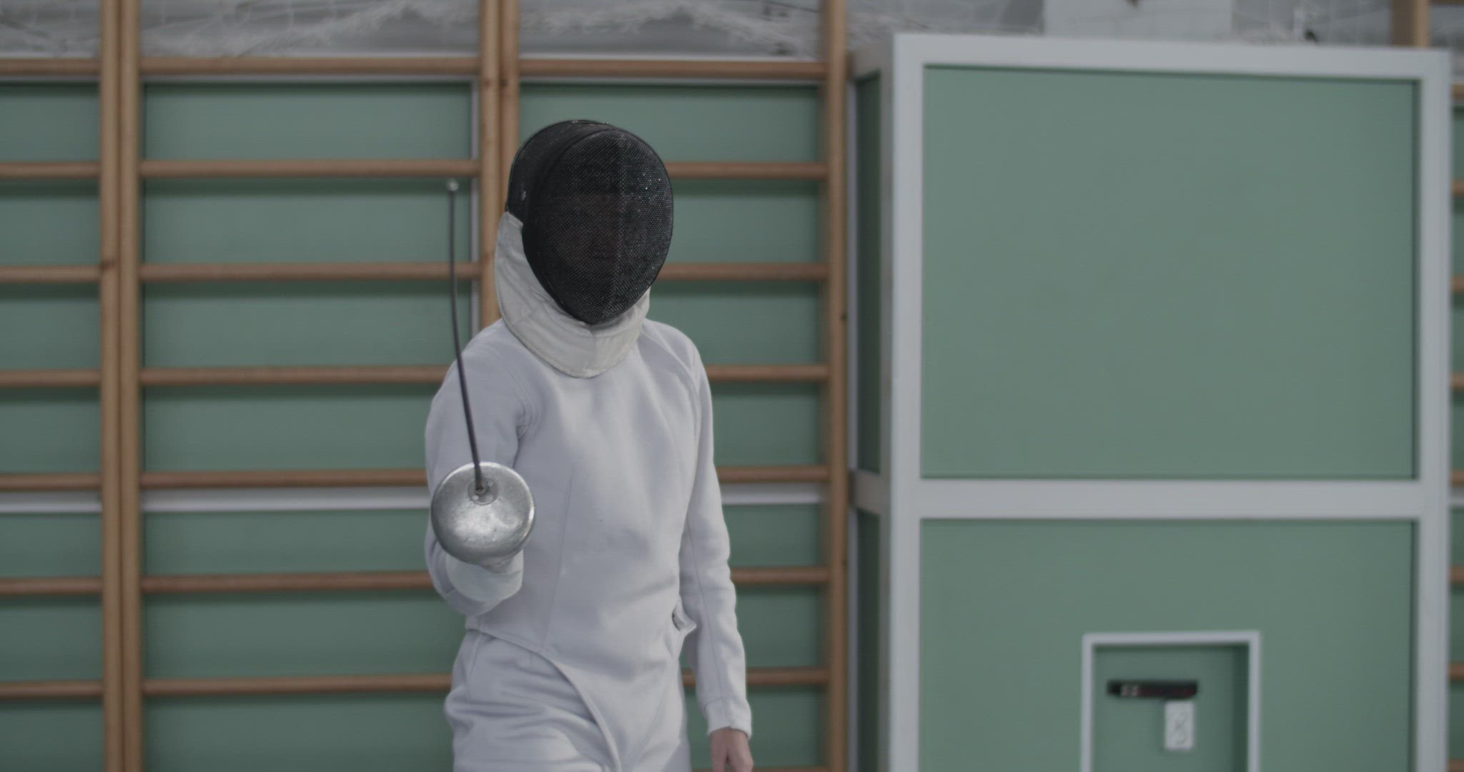 Female fencer charging towards camera