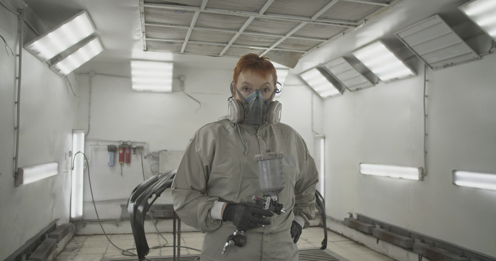 Female painter with spray gun