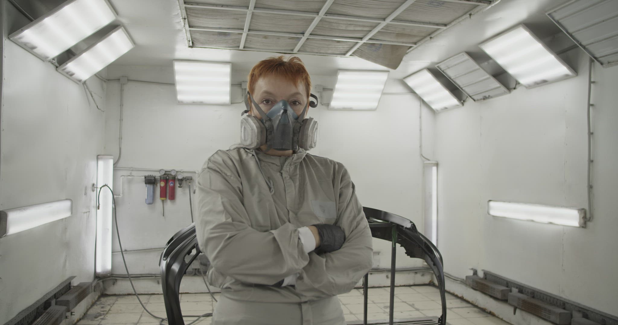 Confident repairwoman near painted bumper