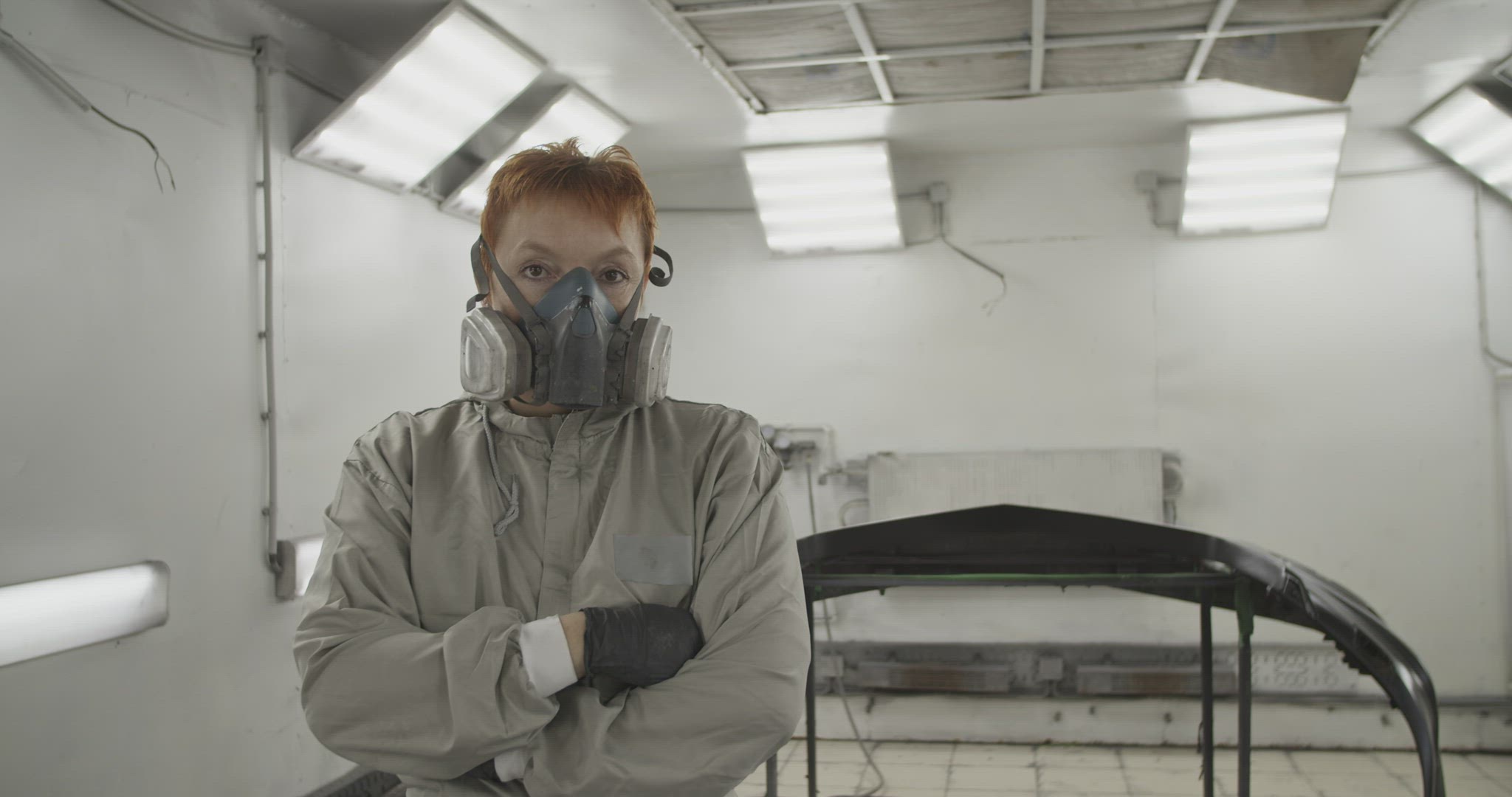 Confident repairwoman near painted bumper