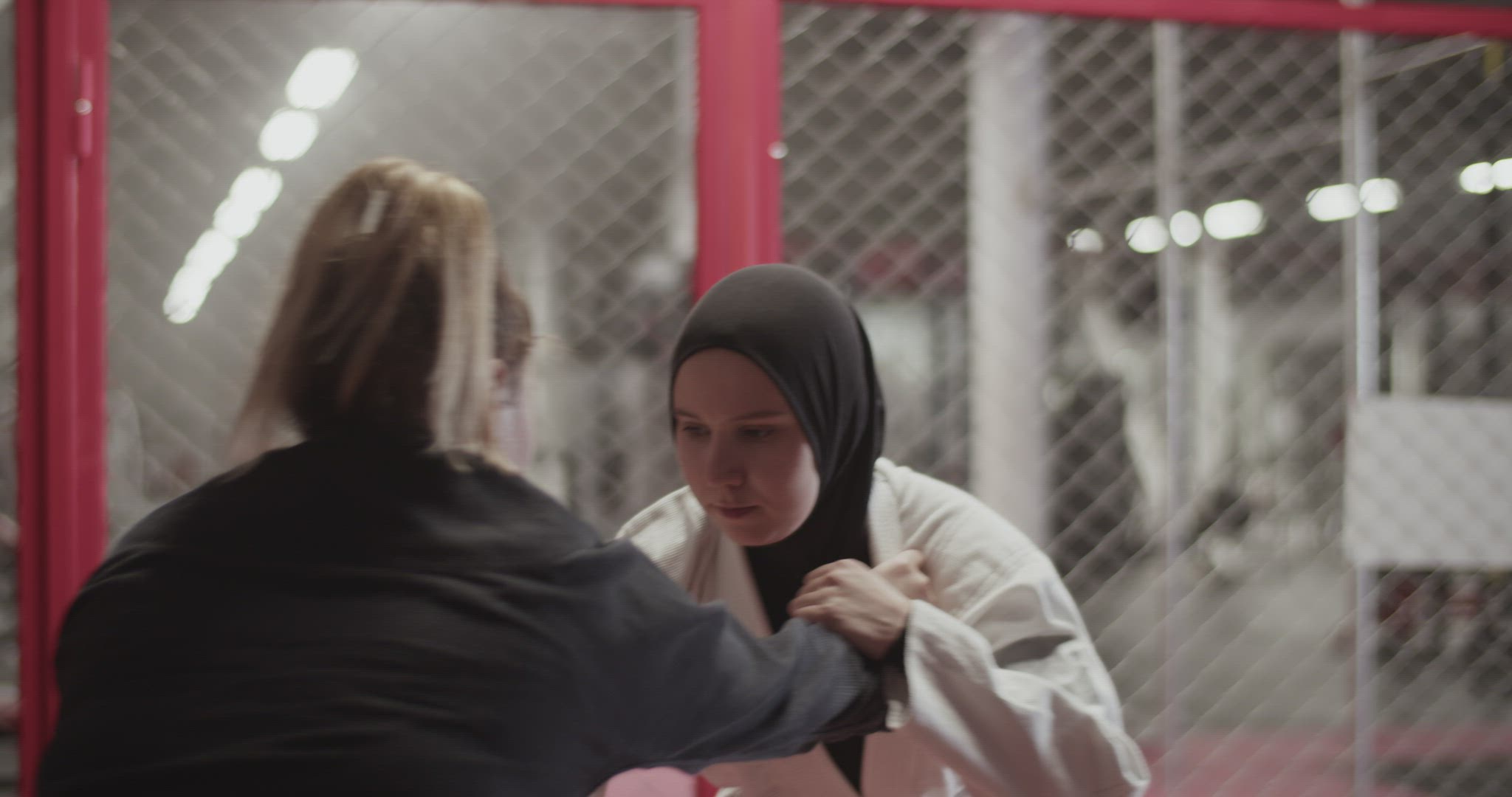 Female fighter trying to grab Muslim opponent