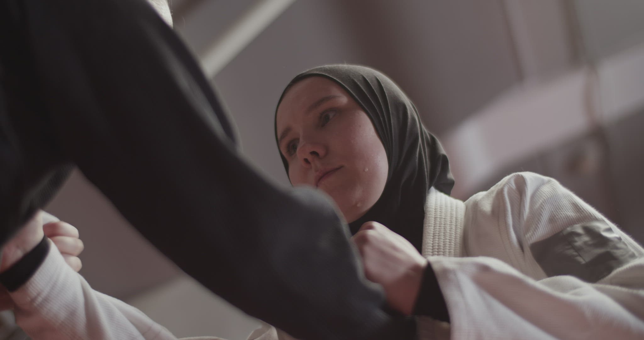 Muslim woman escaping grabs of opponent