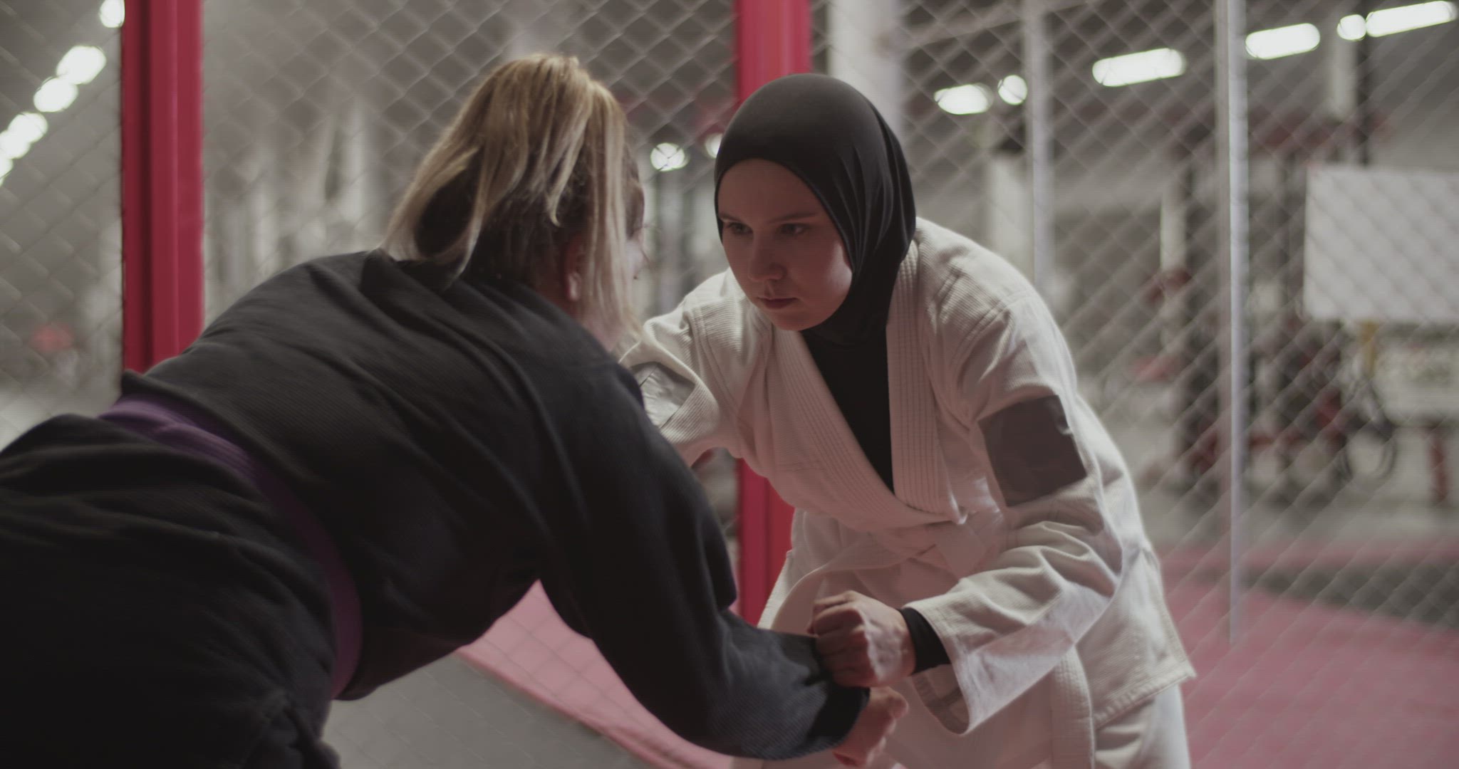 Diverse female wrestlers trying to perform takedown
