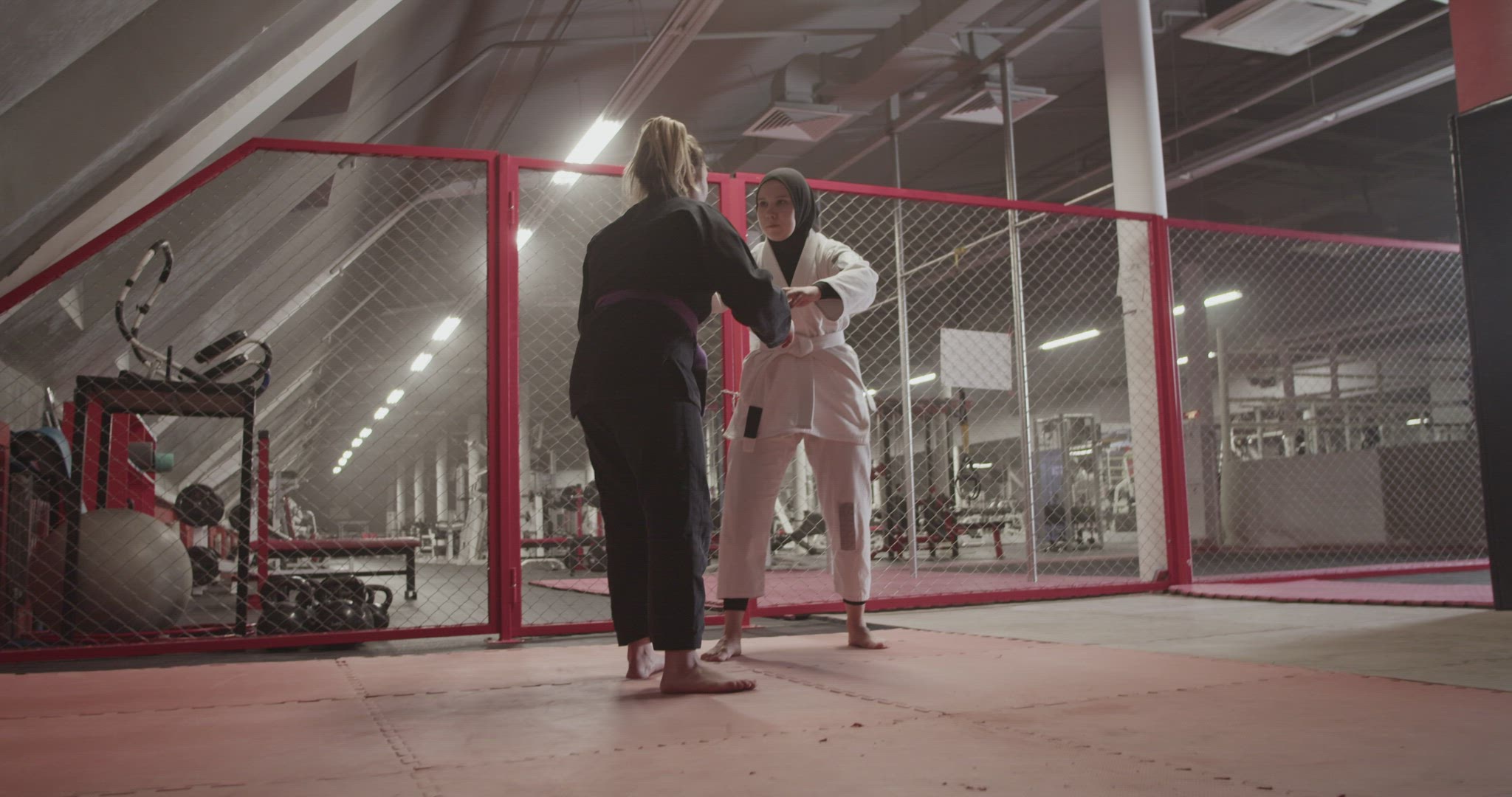 Woman performing takedown and chokehold on Muslim opponent