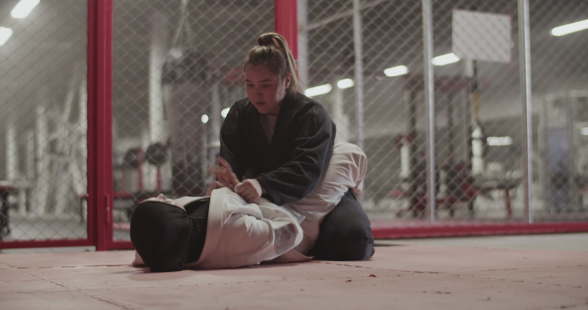 Muslim woman performing triangle choke