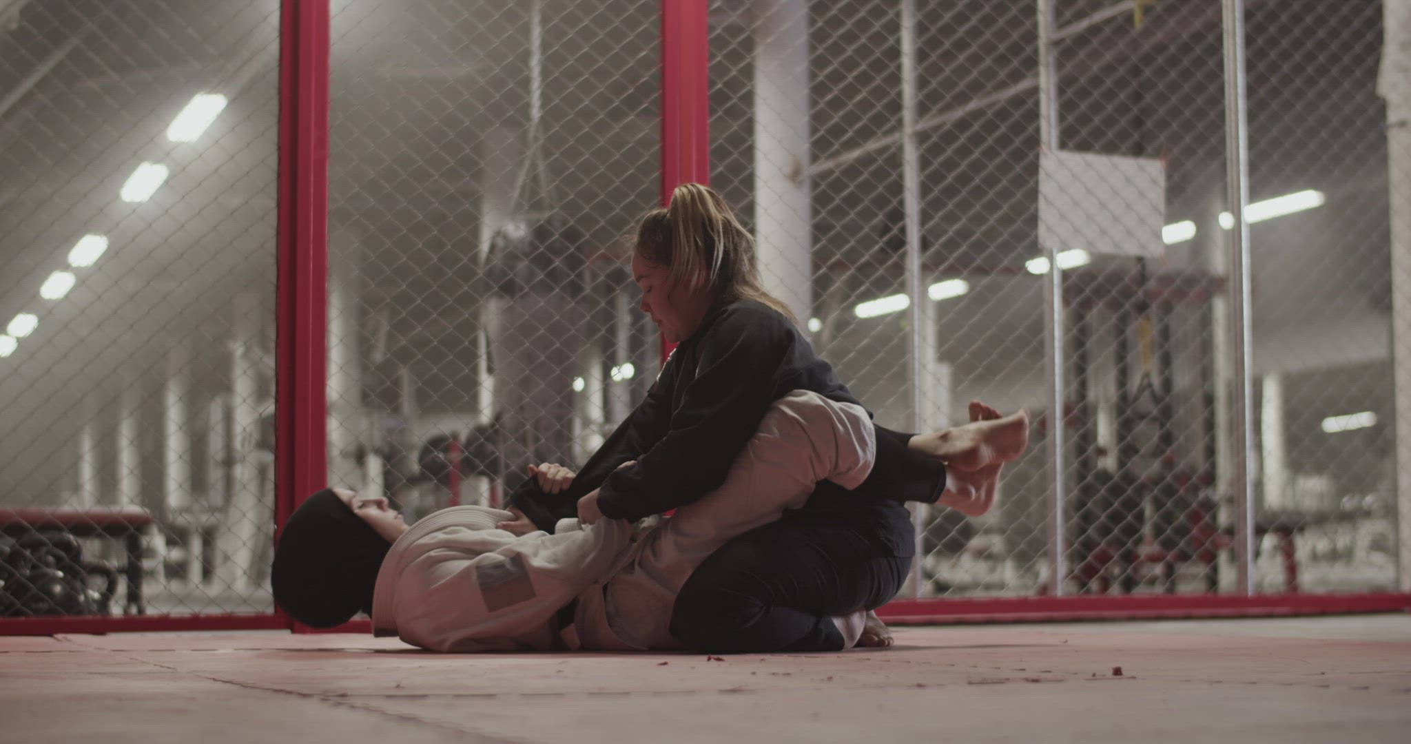 Muslim woman performing triangle choke