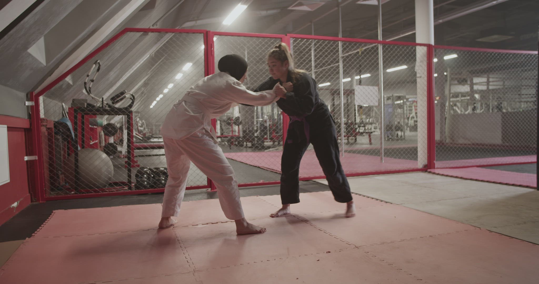 Female wrestlers sparring in gym