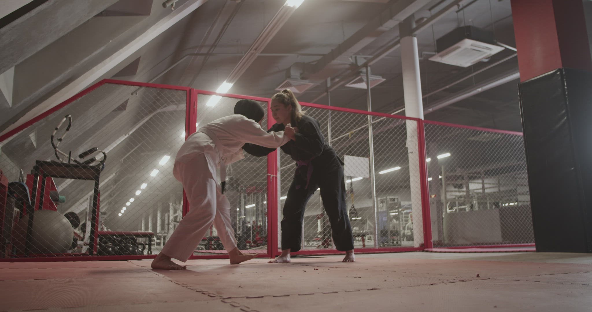 Female wrestlers sparring in gym