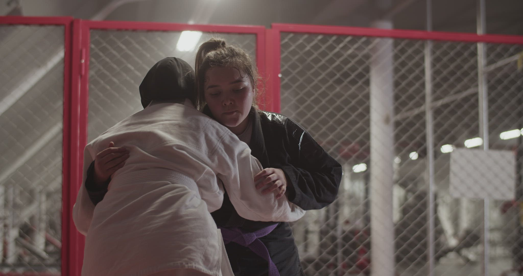 Female fighters clinching during grappling training