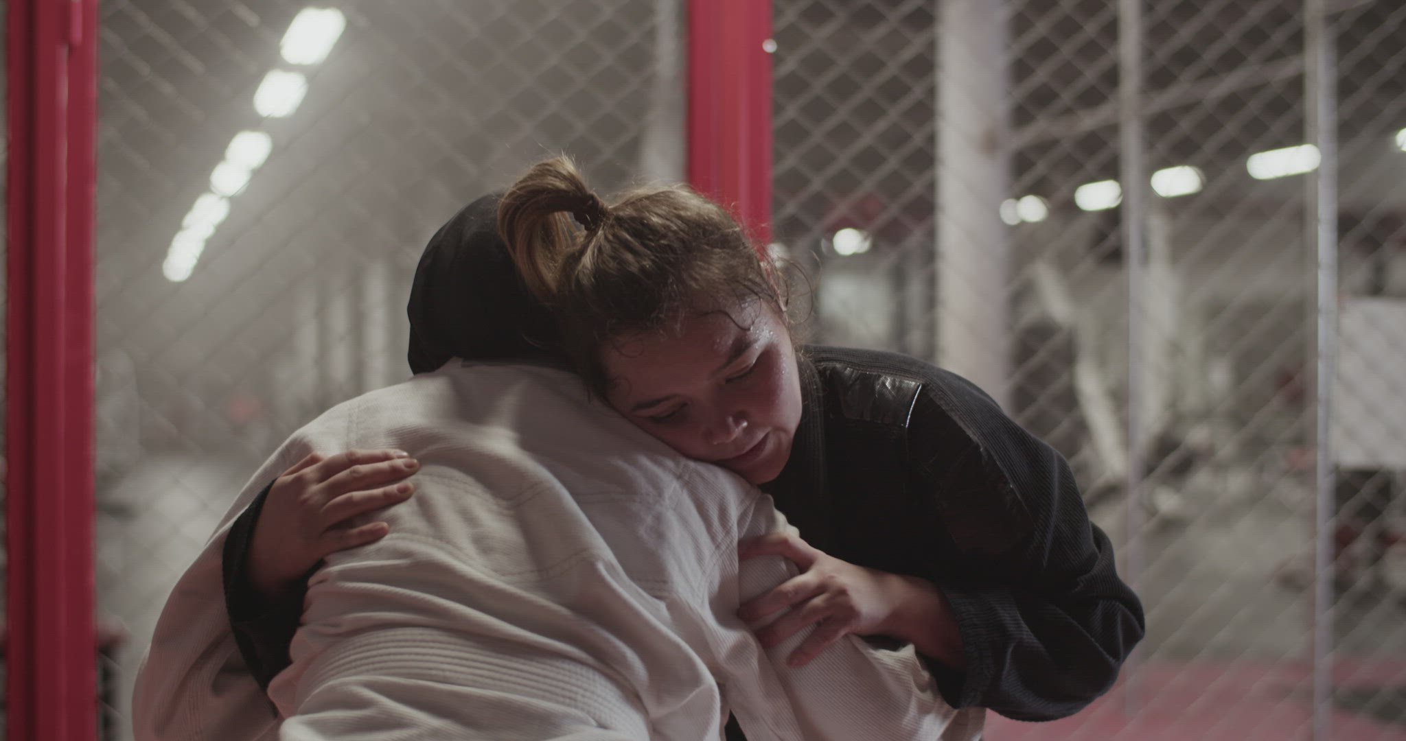 Female fighters clinching during grappling training