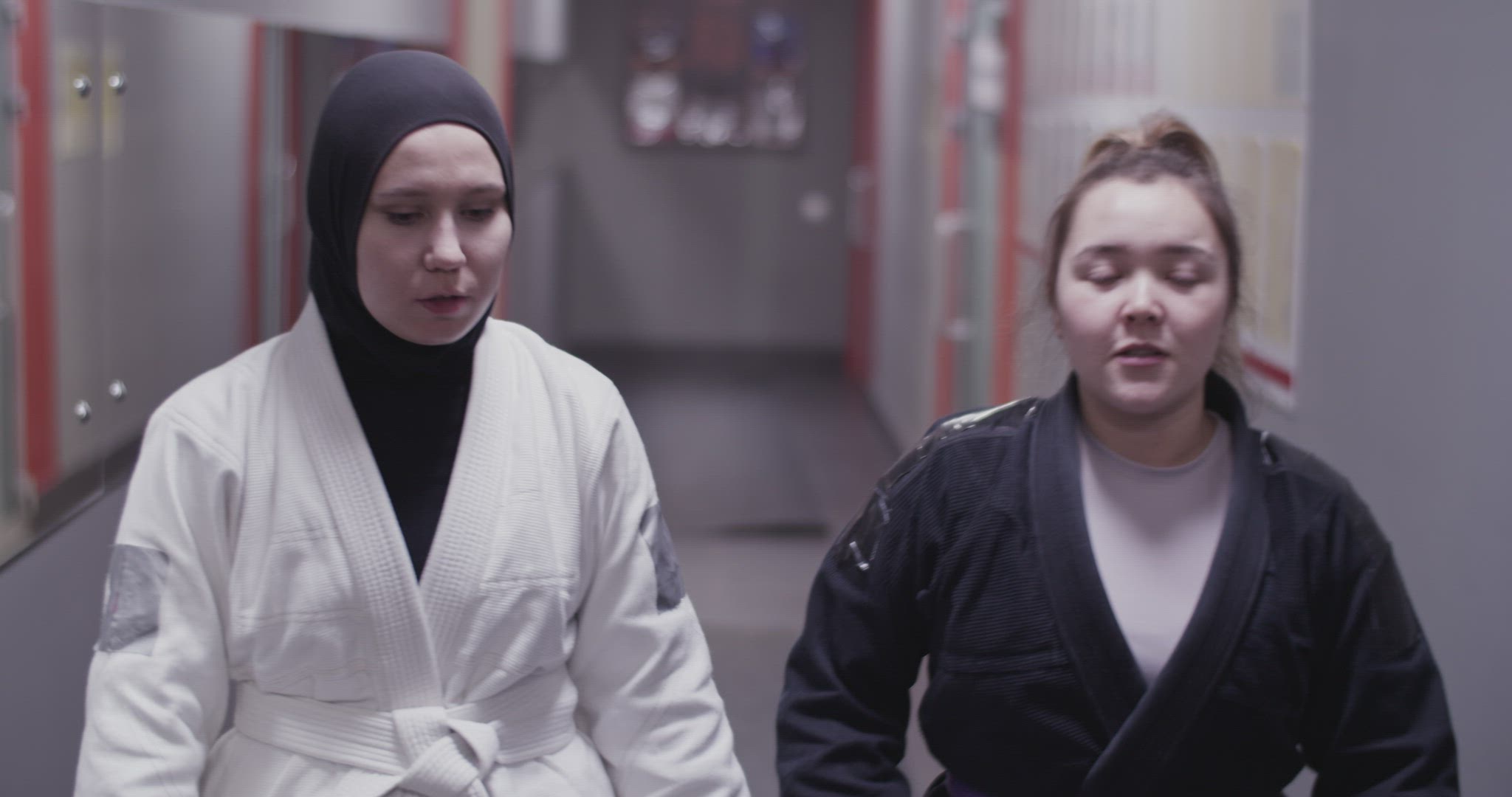 Diverse fighters walking in hallway and chatting