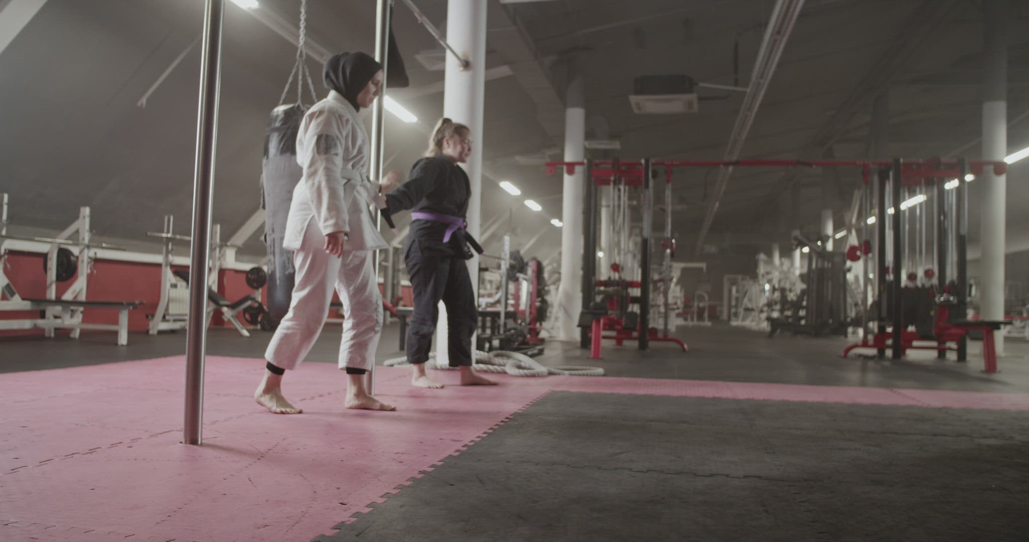 Female wrestlers doing front rolls