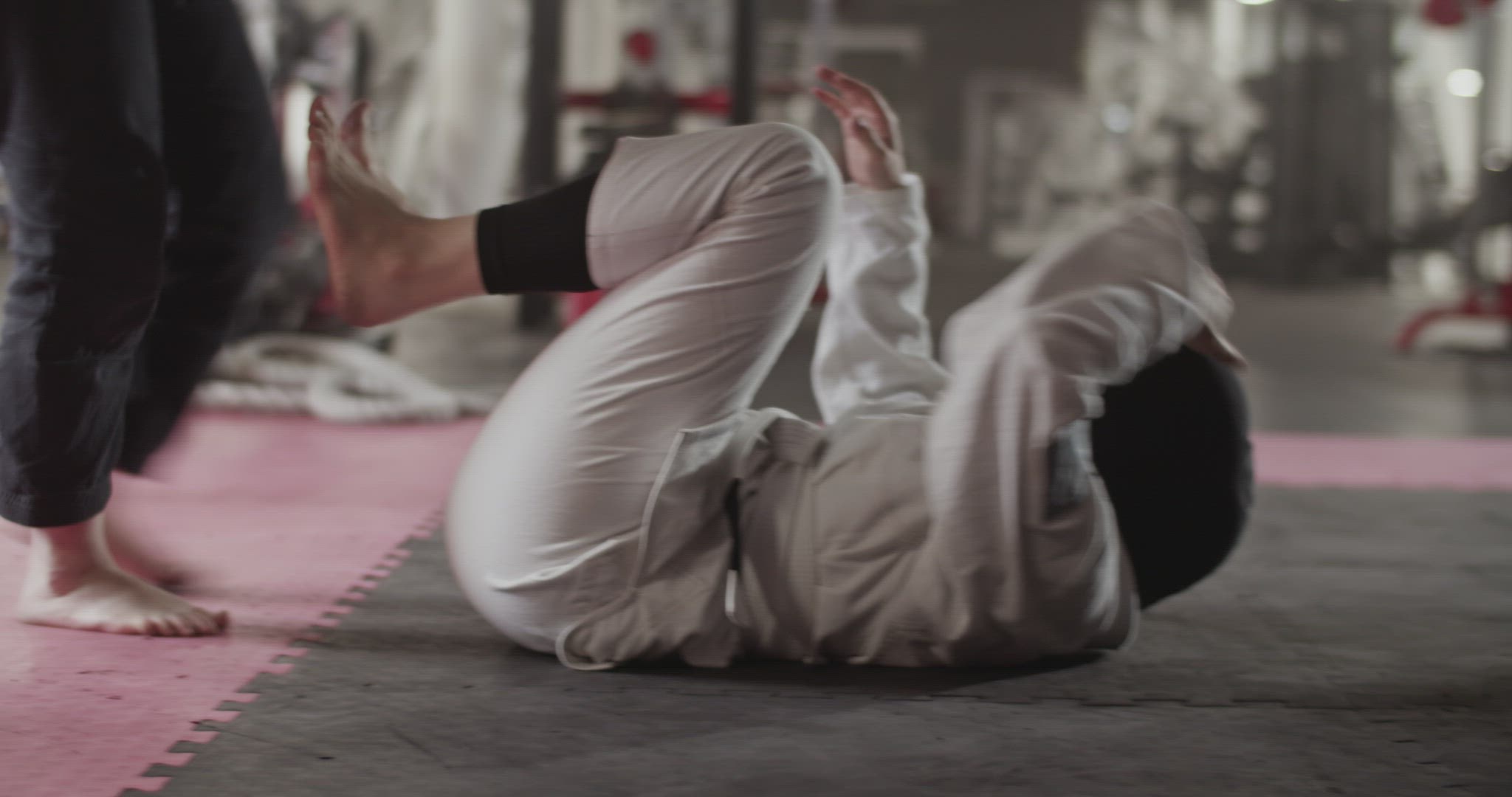 Crop trainer helping Muslim fighter to practice escape technique