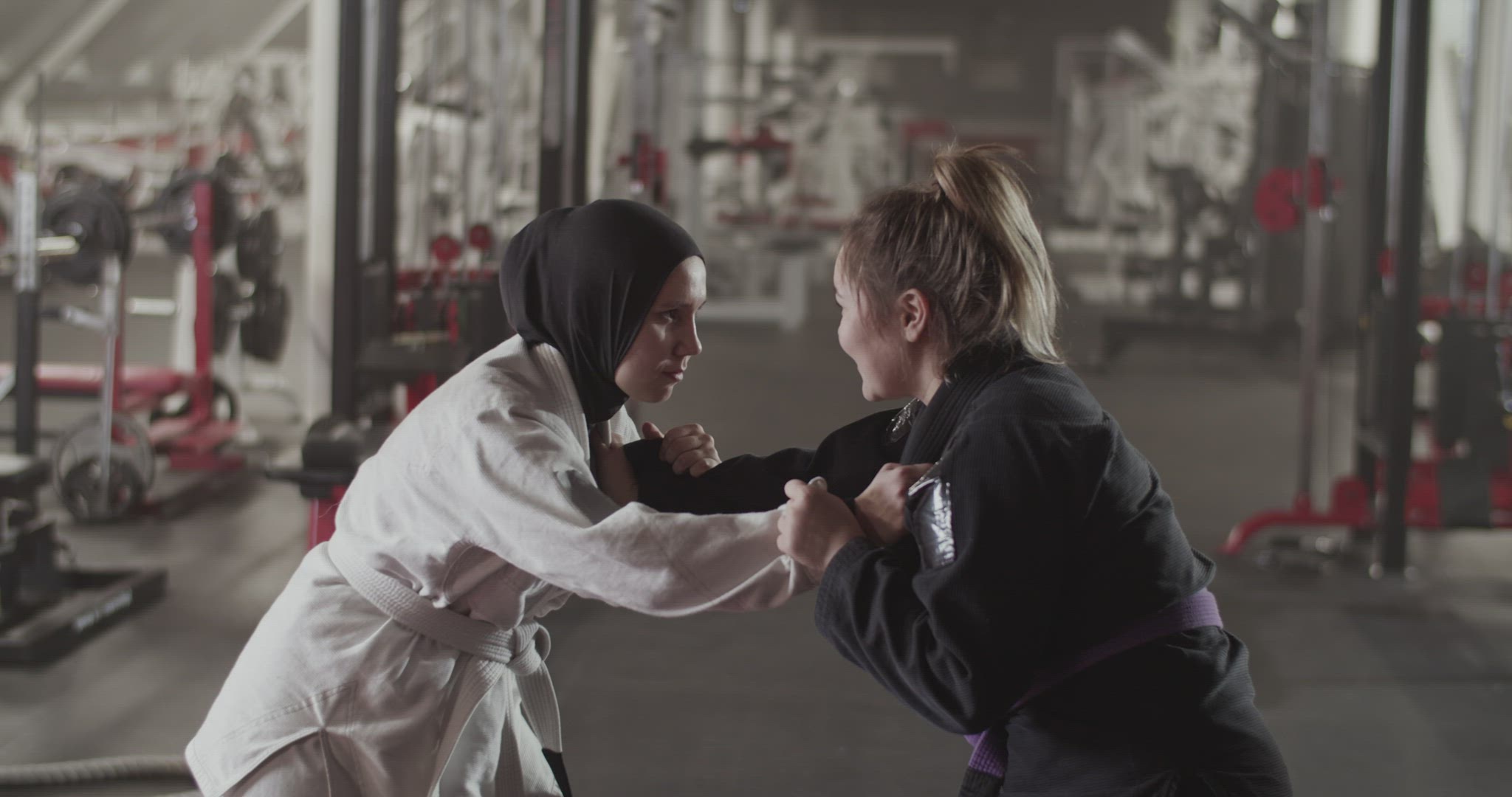 Muslim woman clinching with female opponent