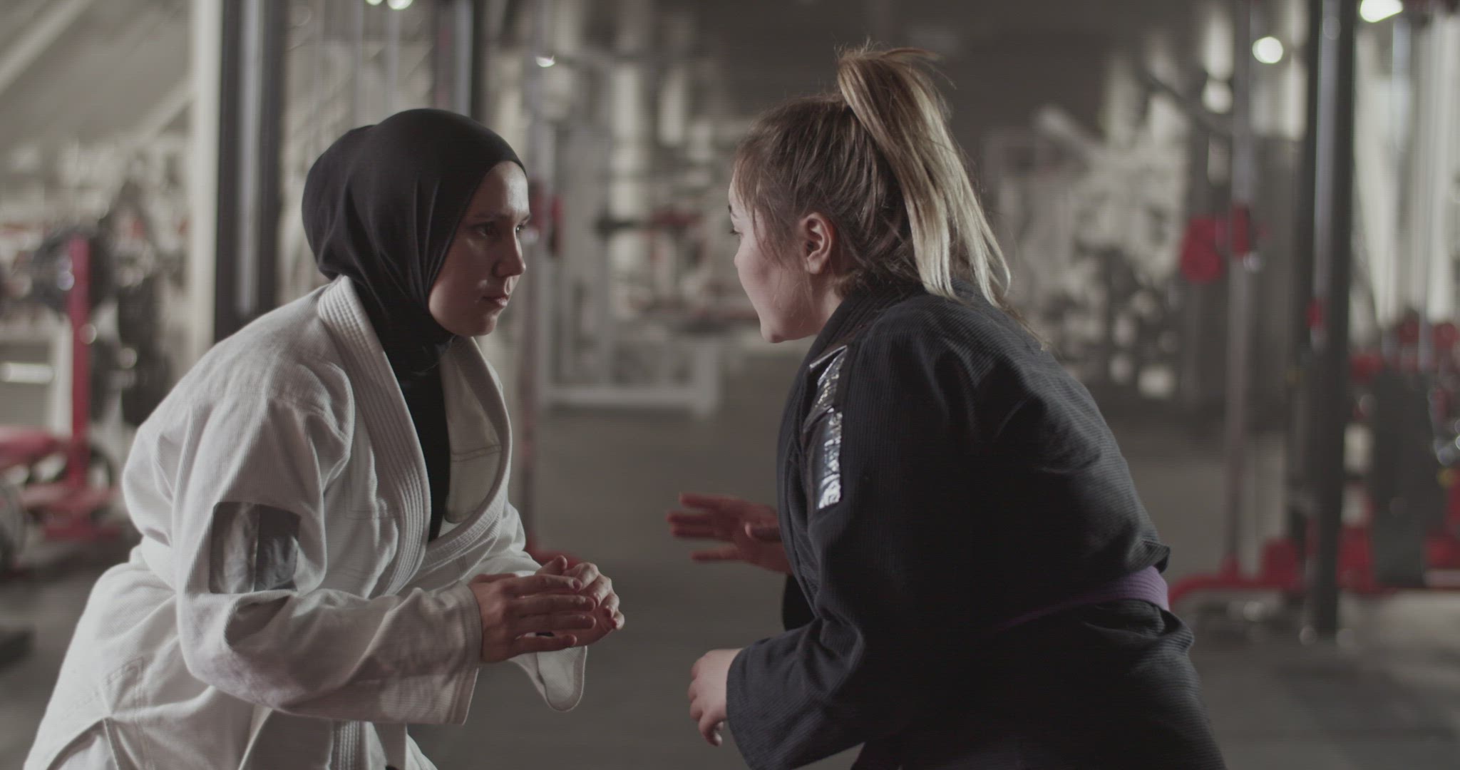 Muslim woman clinching with female opponent