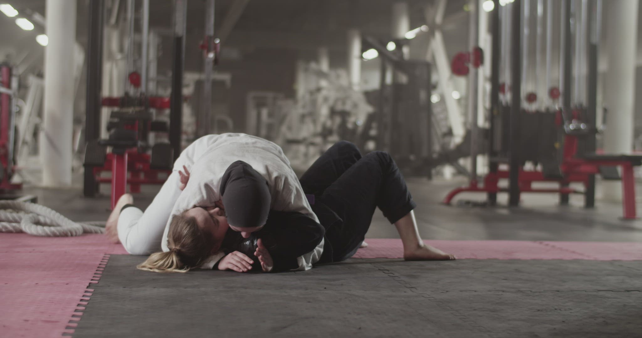 Muslim woman wrestling with opponent on floor
