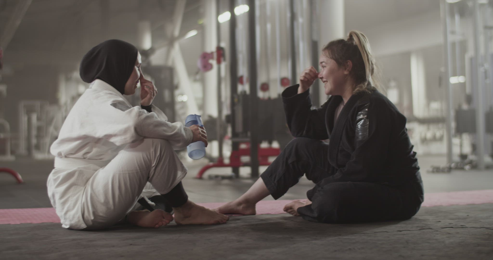 Female trainer speaking with Muslim wrestler