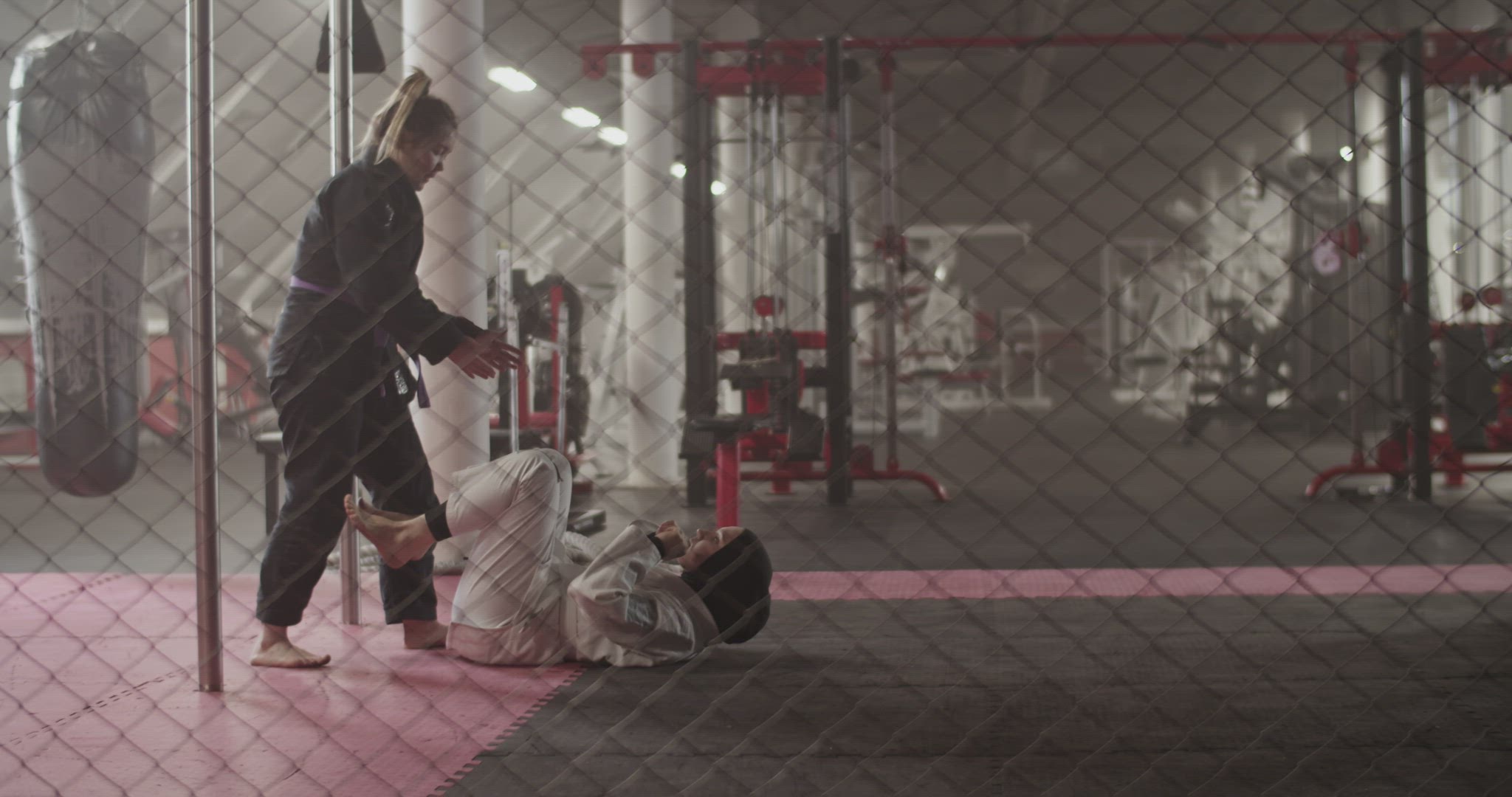 Female fighters practicing BJJ escape technique