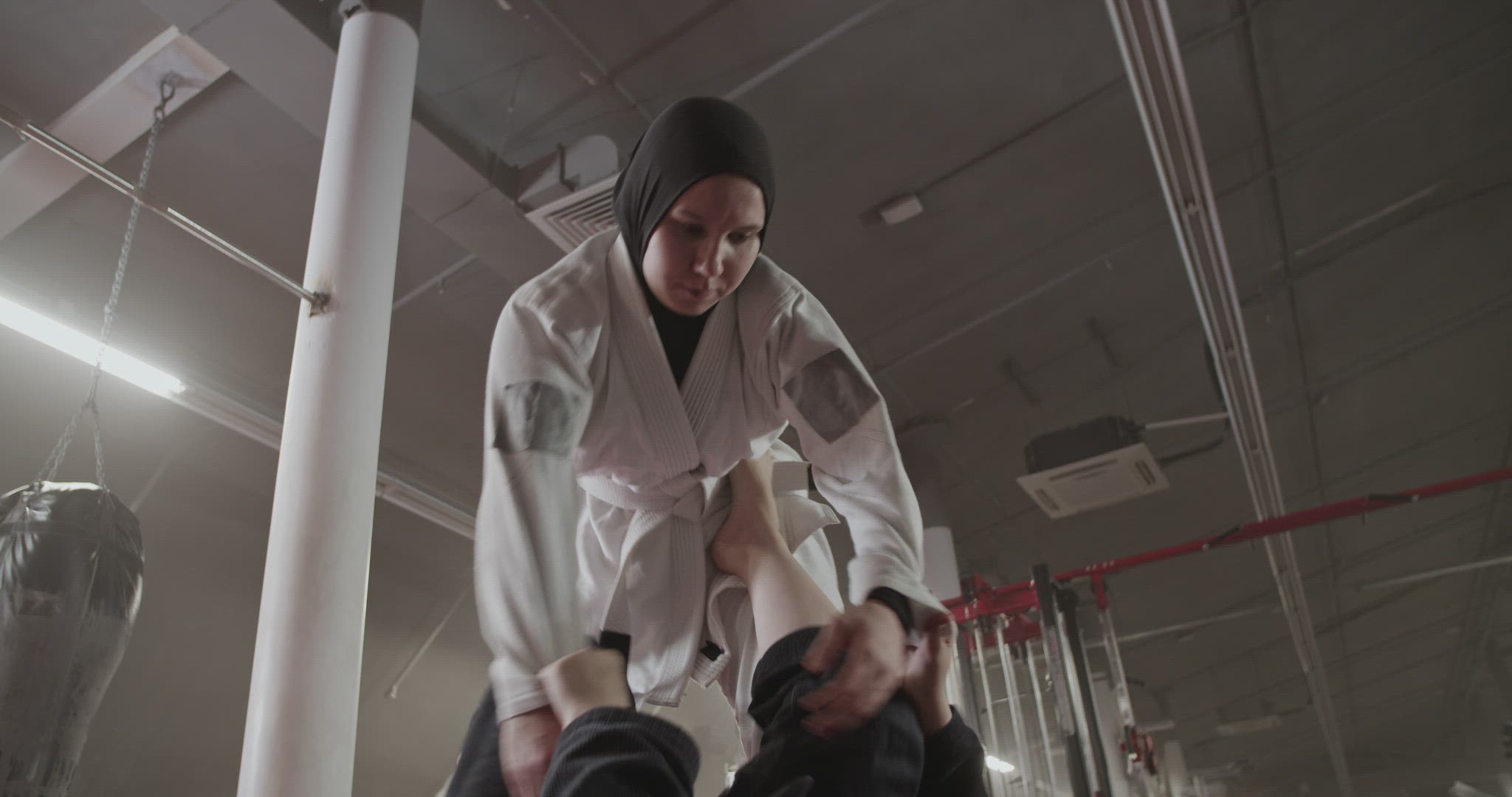 Muslim female fighter sparring with opponent