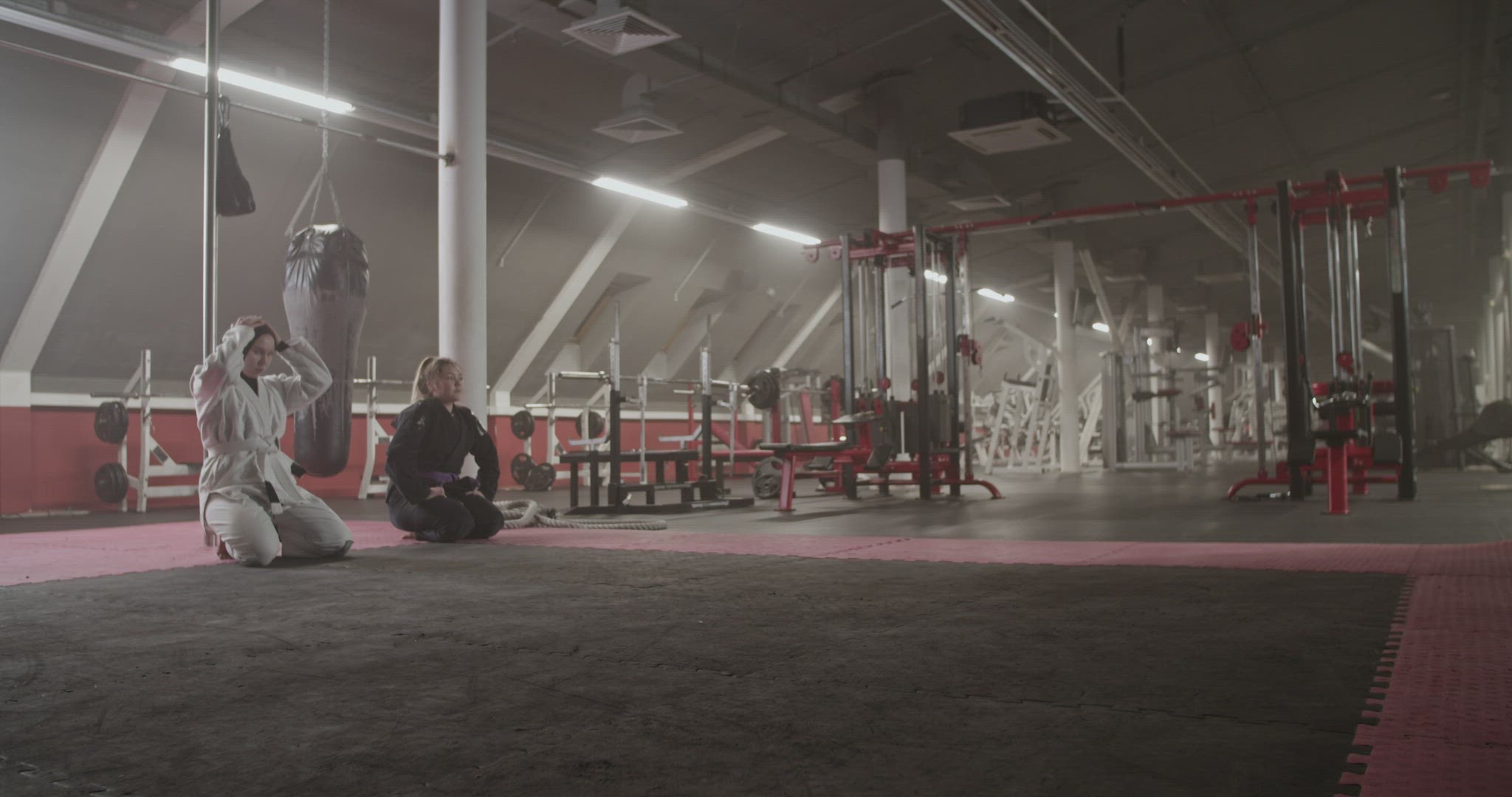 Diverse women practicing BJJ rolls in gym