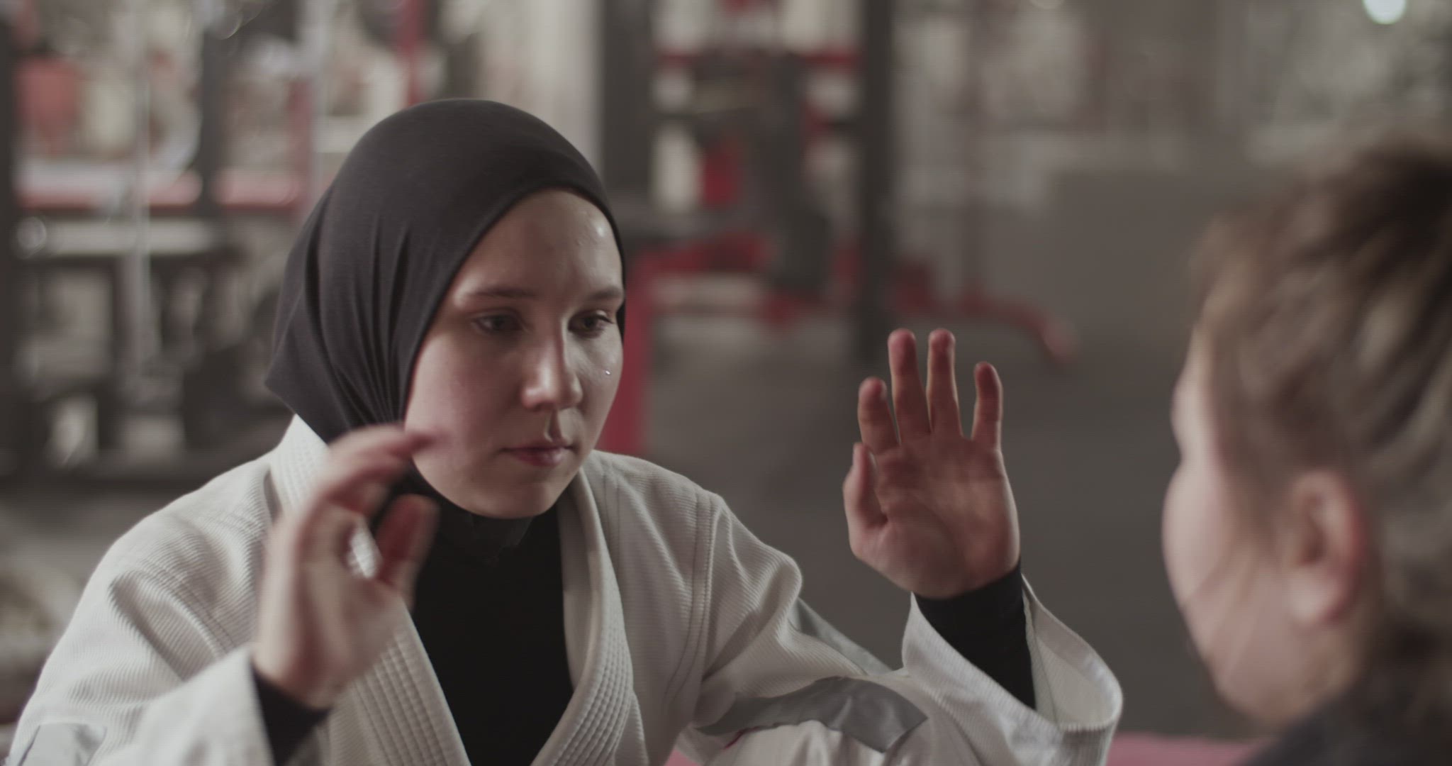 Muslim fighter doing sit ups with partner