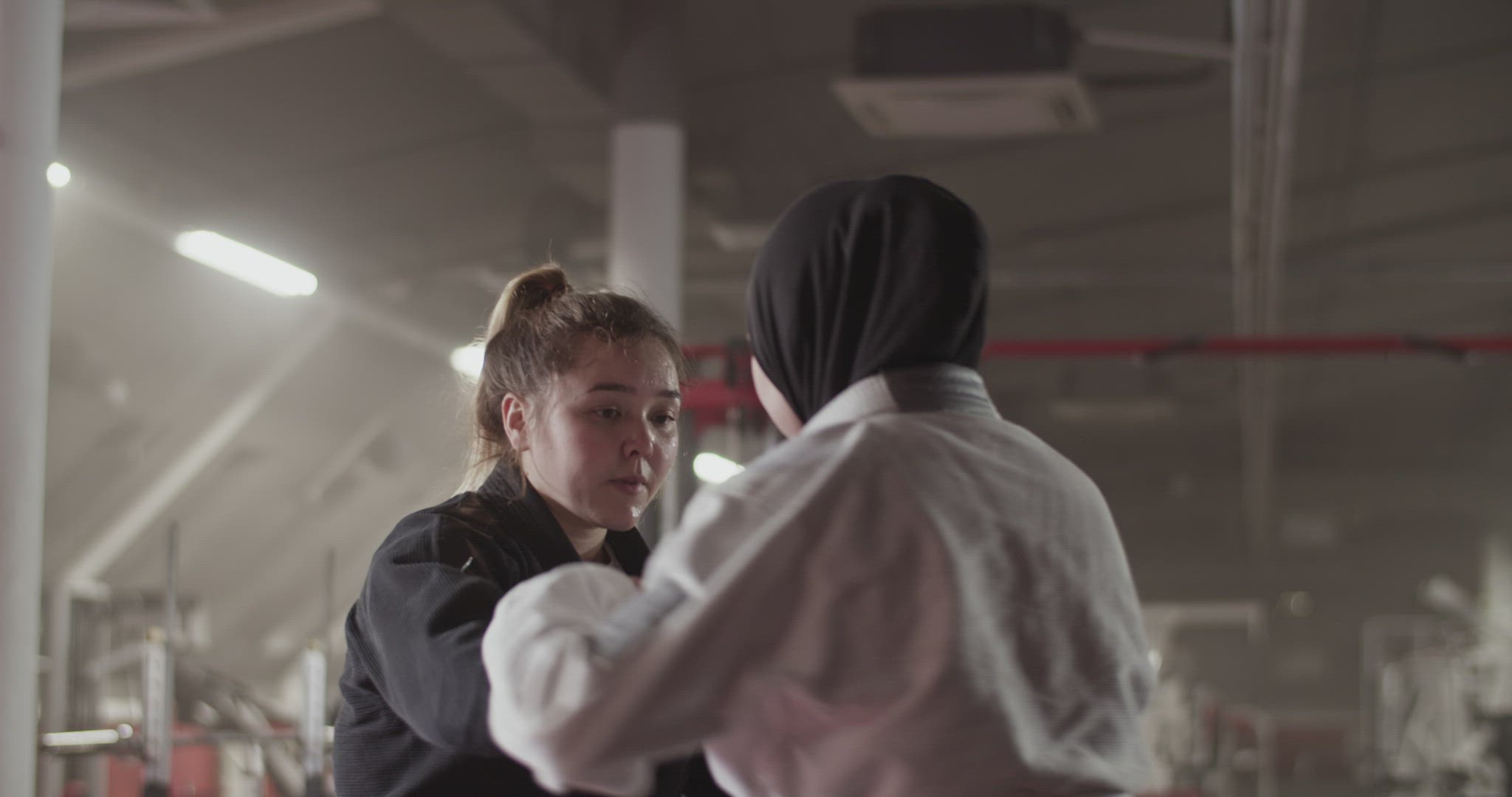 Blond woman clenching with Muslim opponent