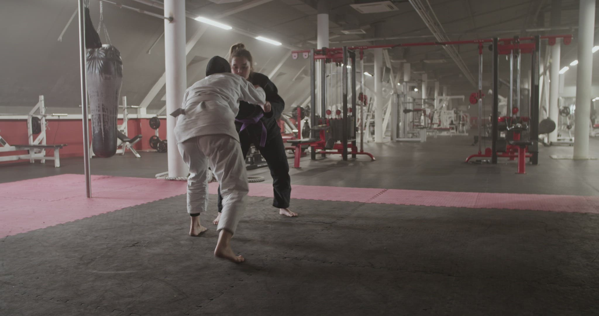 Female wrestlers fighting in gym