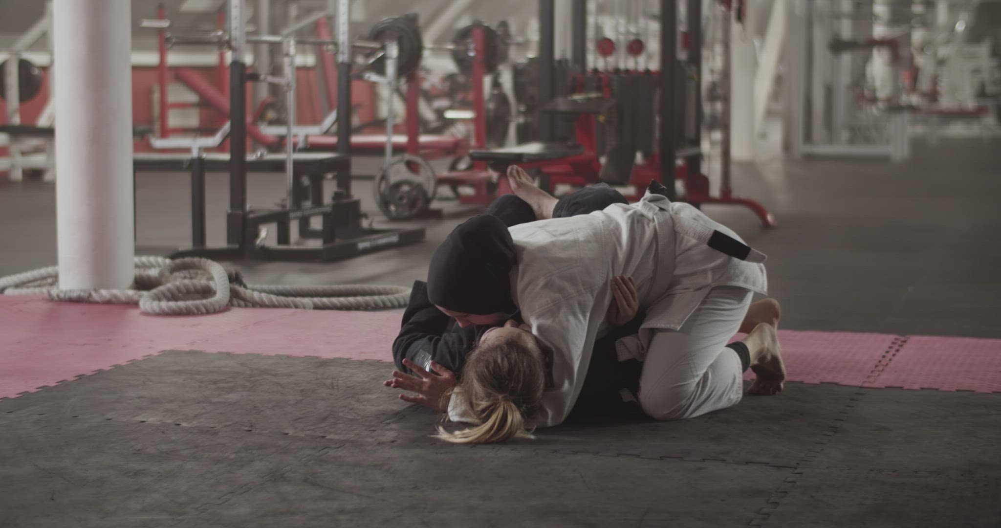 Women practicing grappling holds on floor