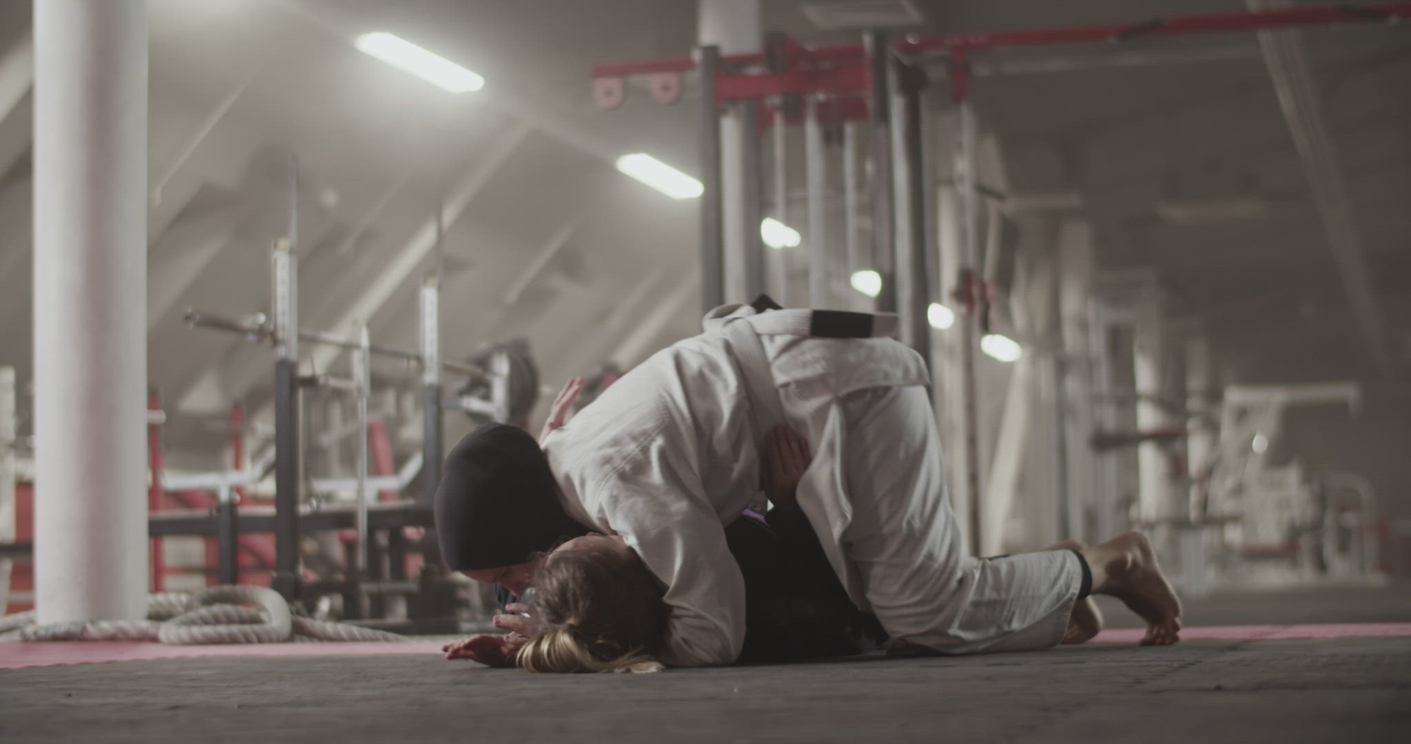 Women practicing grappling holds on floor