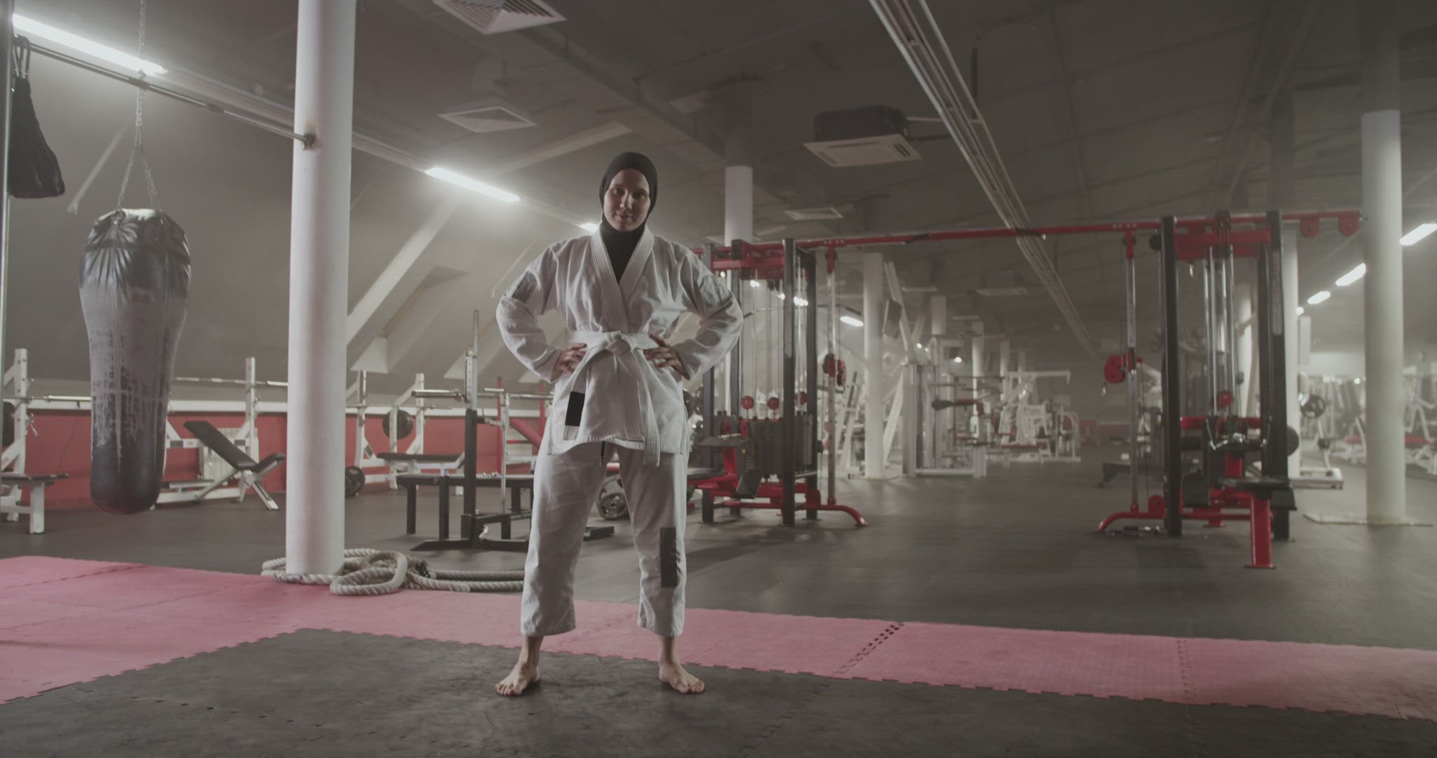 Barefoot BJJ fighter with crossed arms